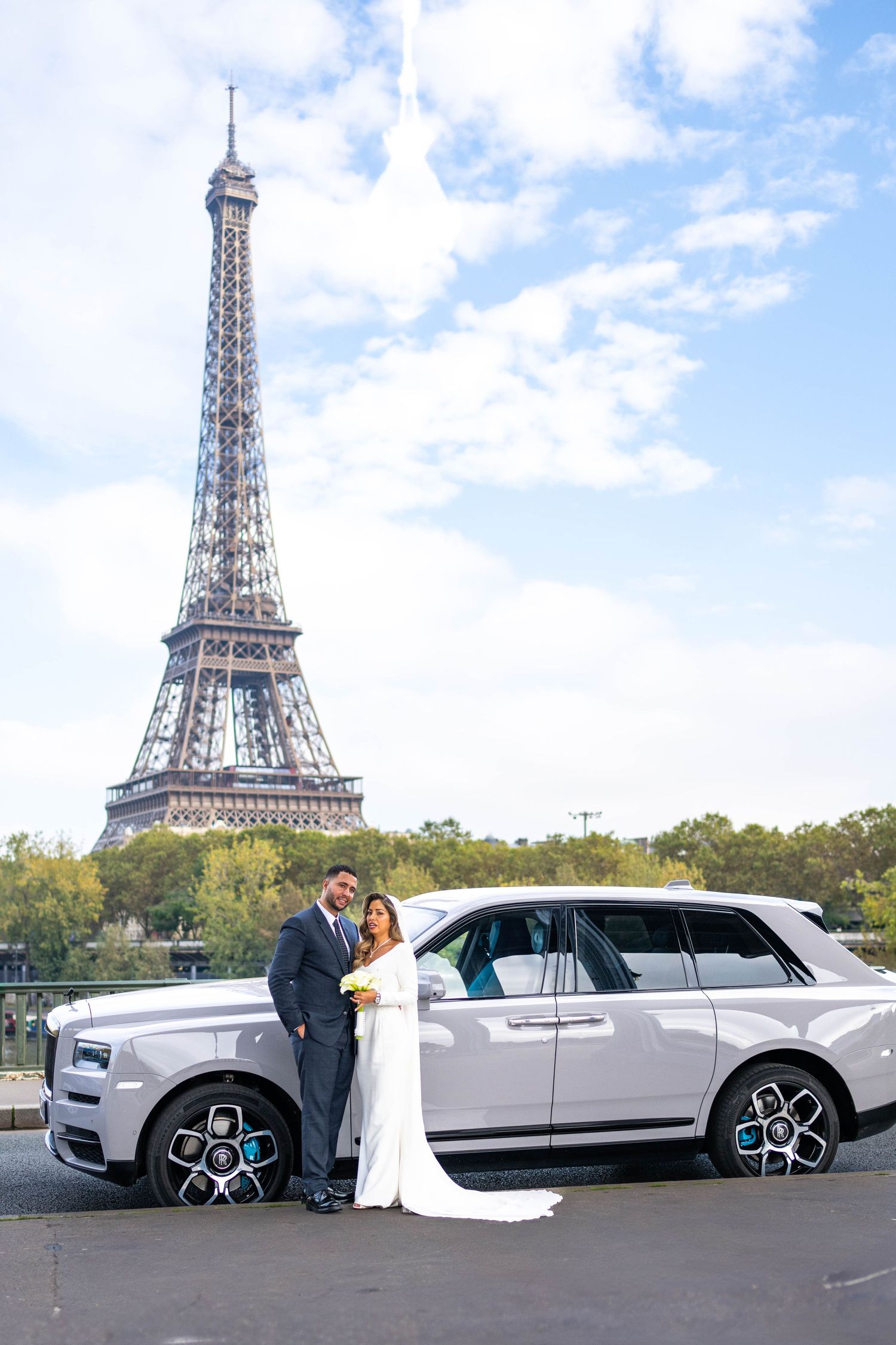 Wedding photos with Eiffel Tower backdrop featuring luxury white Rolls Royce.