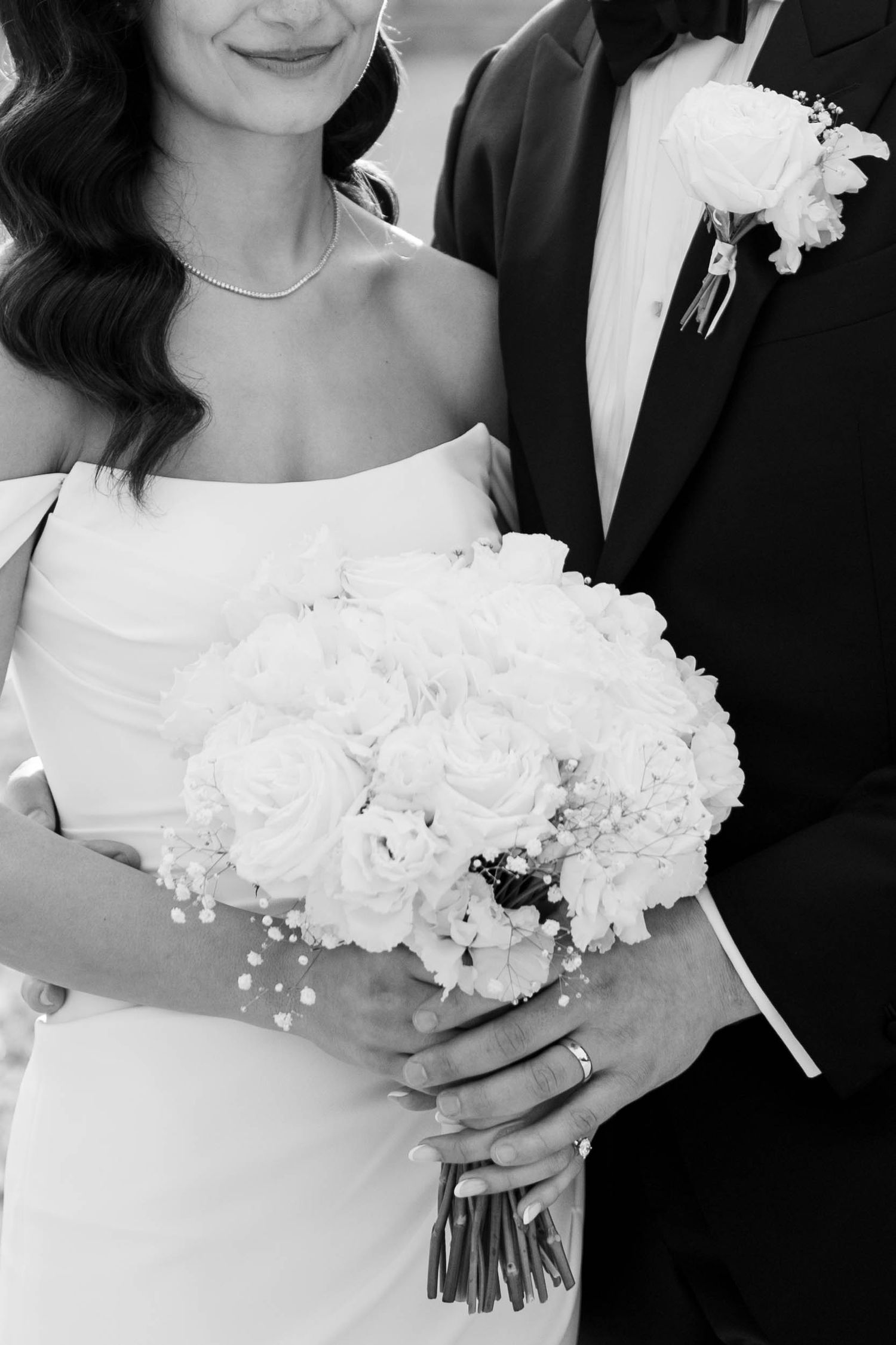 Black and white wedding photos showing elegant bouquets of white flowers against formal attire.