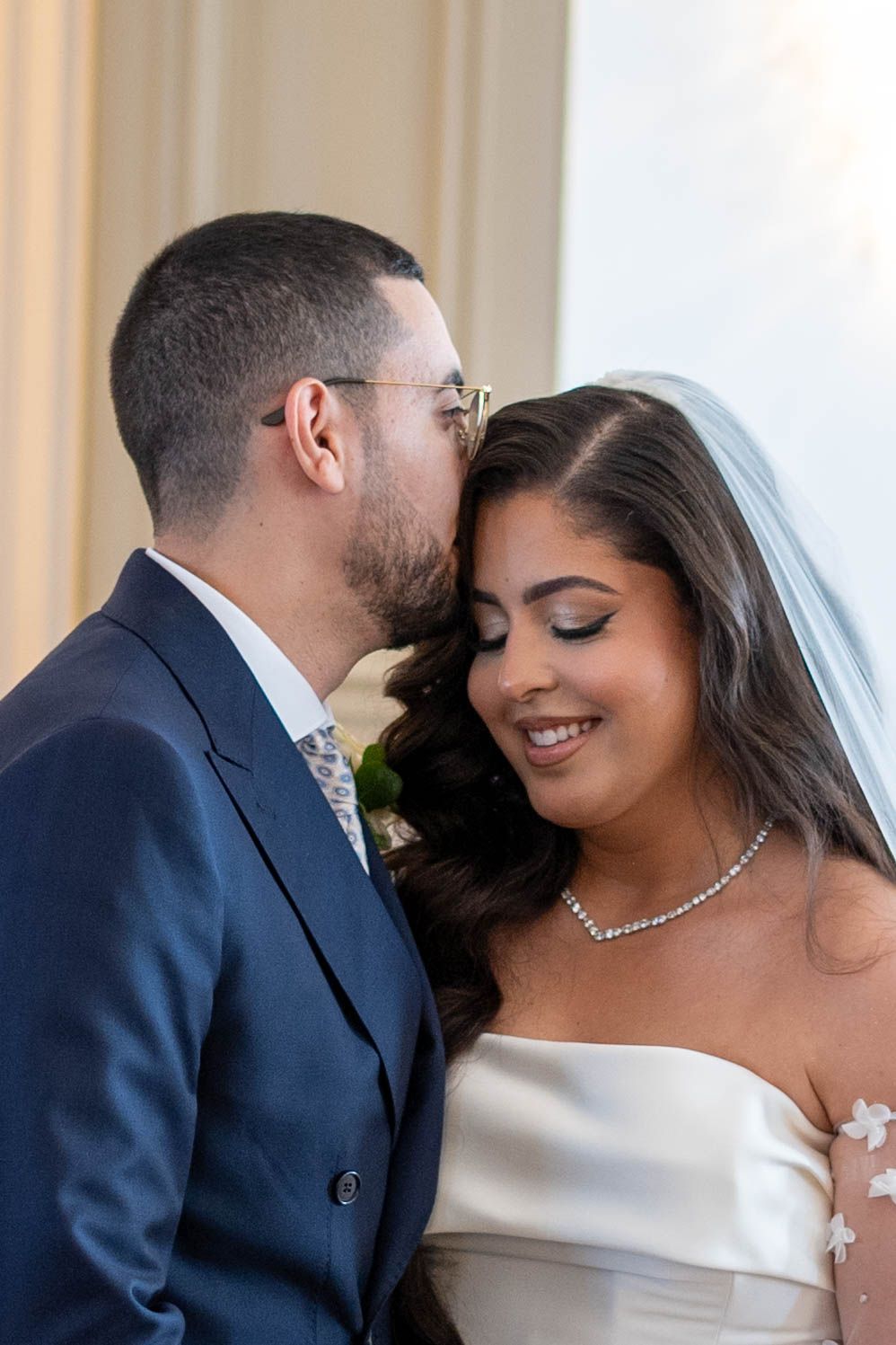 A romantic wedding couple shares tender moments in a series of intimate portrait photographs.