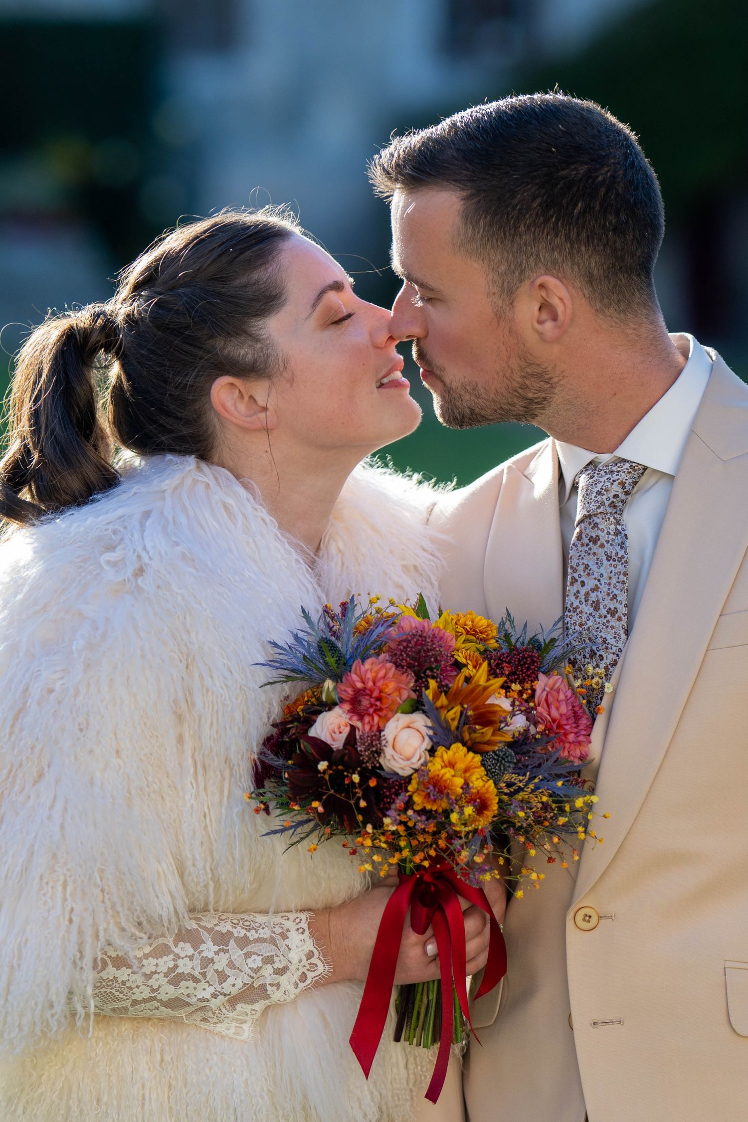 Romantic wedding portrait series with autumn bouquet featuring sunflowers and burgundy flowers.