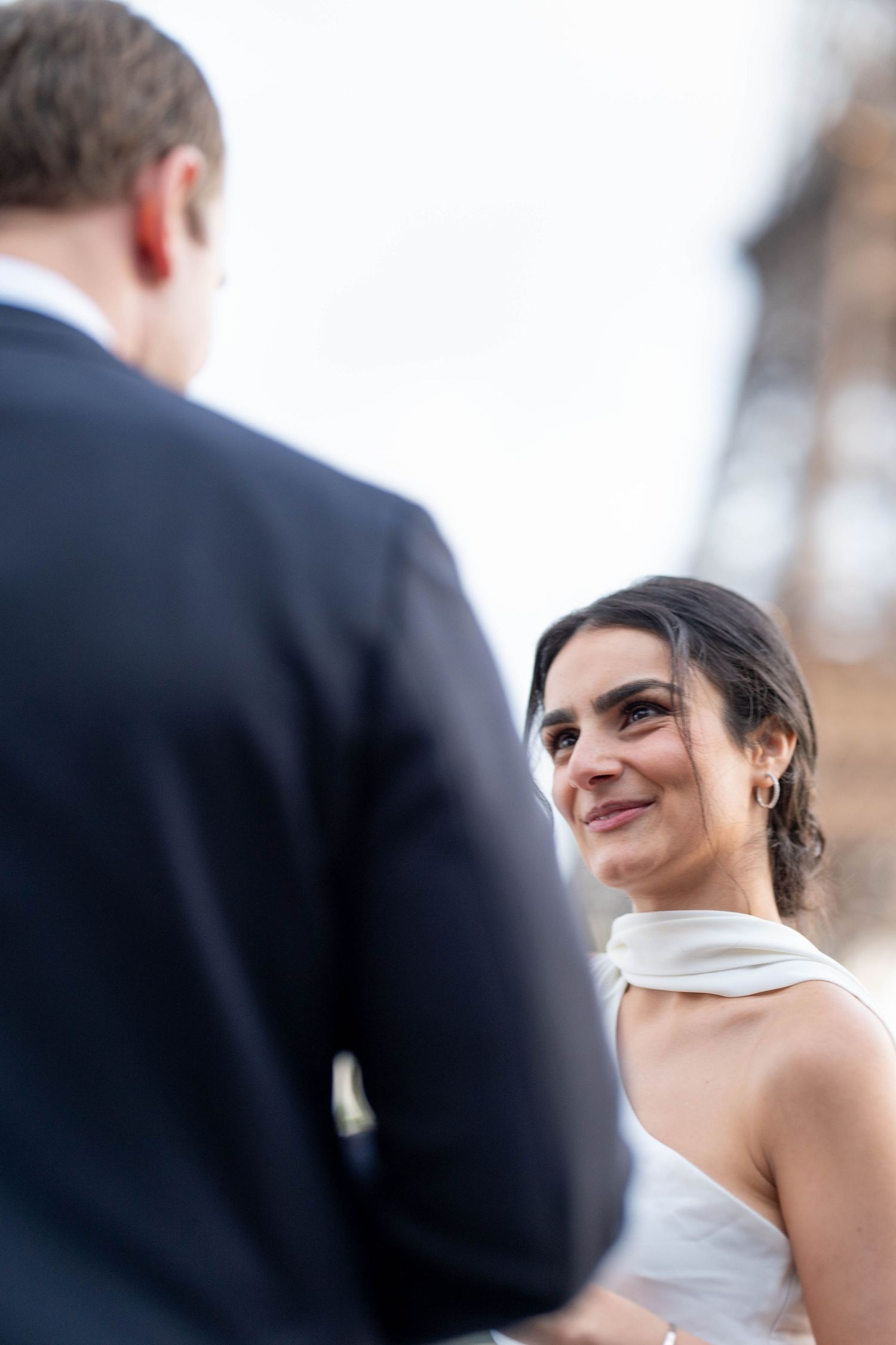 A bride and groom share an intimate moment during their outdoor wedding ceremony.