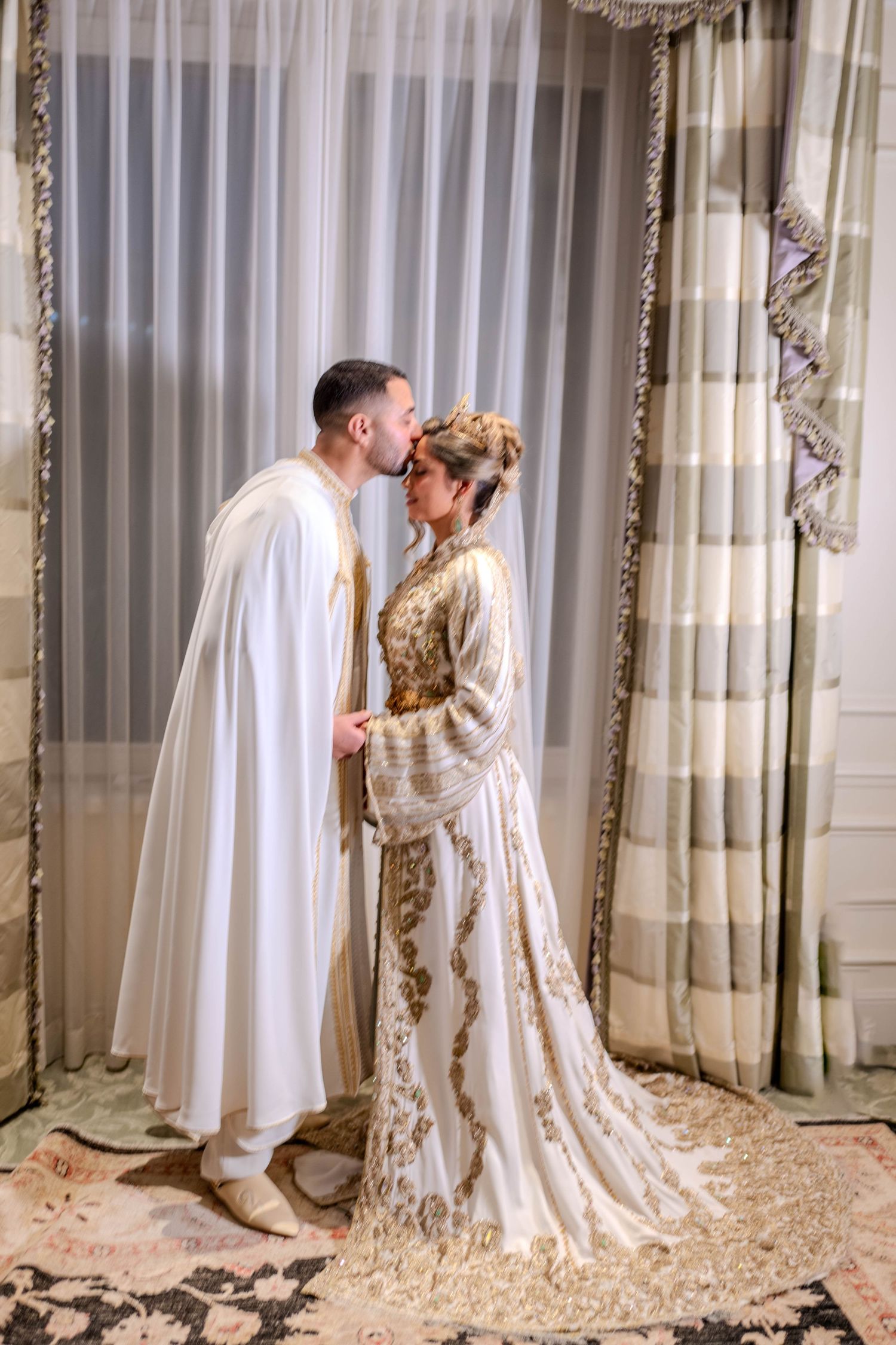 A romantic wedding photoshoot sequence showing a couple in white and gold attire against elegant curtains.