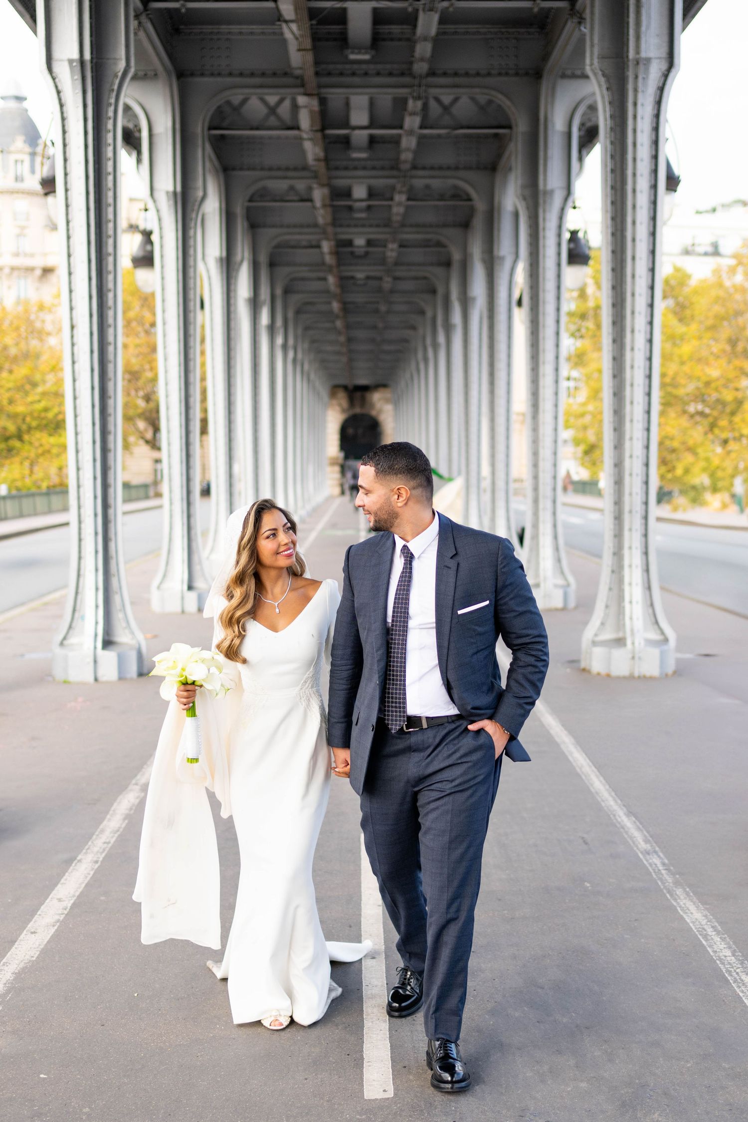 Elegant wedding photos taken under Parisian bridge architecture.