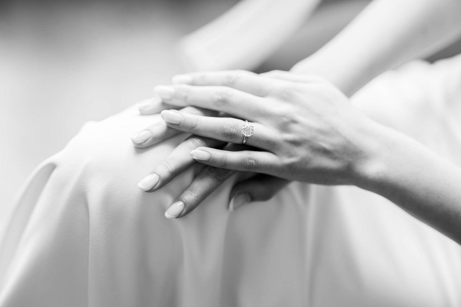 Black and white close-up photograph of hands in various expressive poses against a light background.