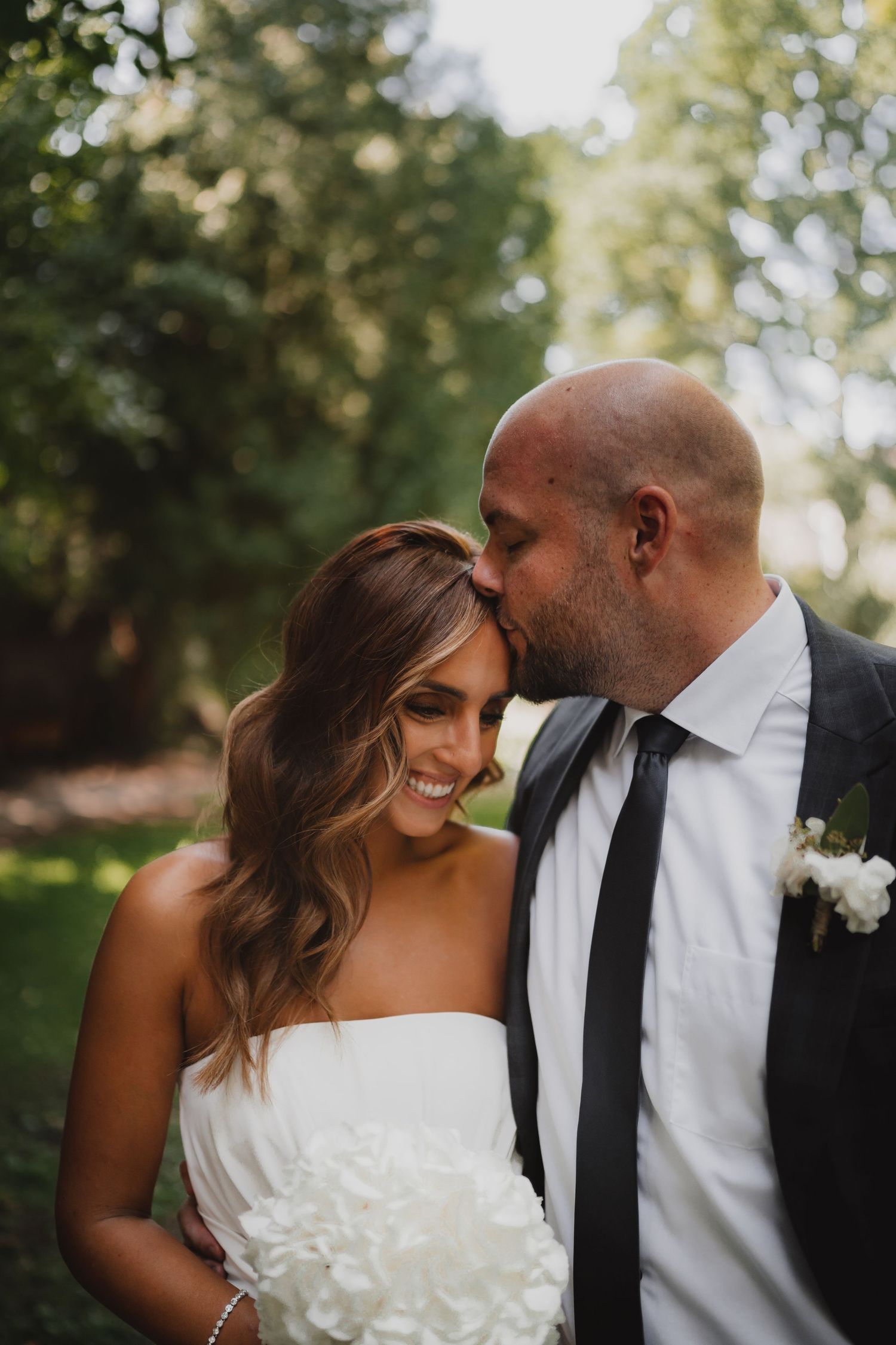 Romantic wedding moment captured during an outdoor photo session.