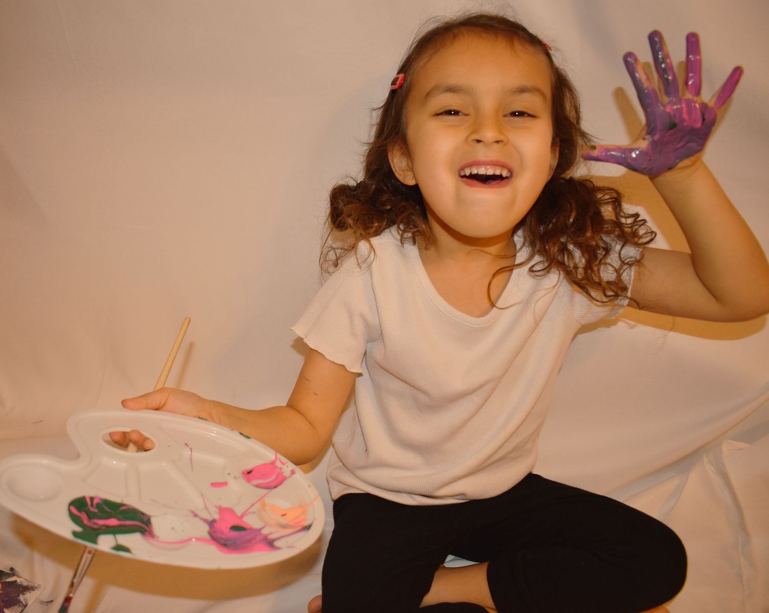 Hands covered in colorful paint during creative art activity.