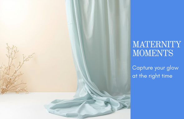 Soft blue draped fabric backdrop for maternity photography studio sessions, with elegant minimalist decor and warm neutral tones.