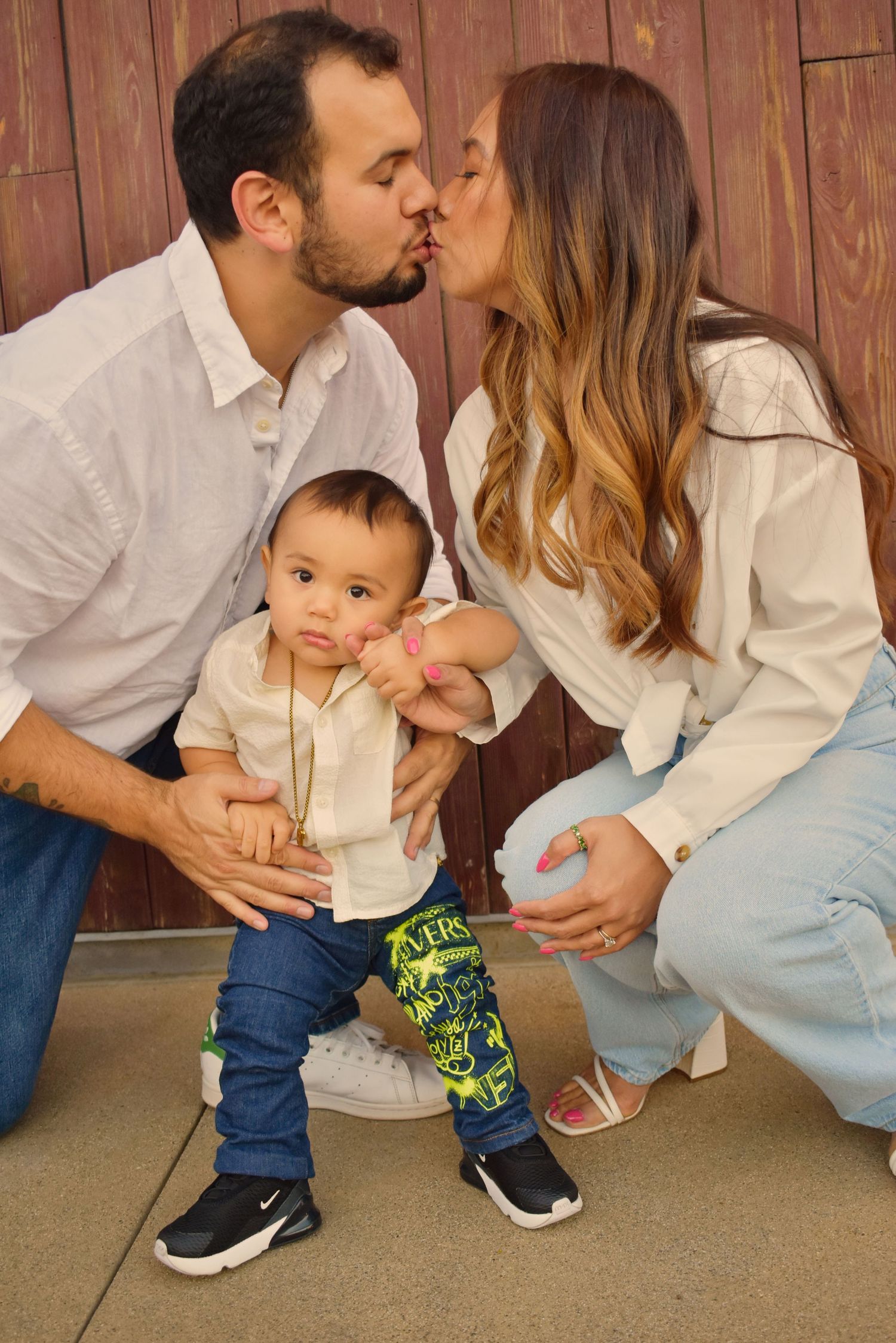 Family shares loving moments together while dressed in coordinating casual outfits.