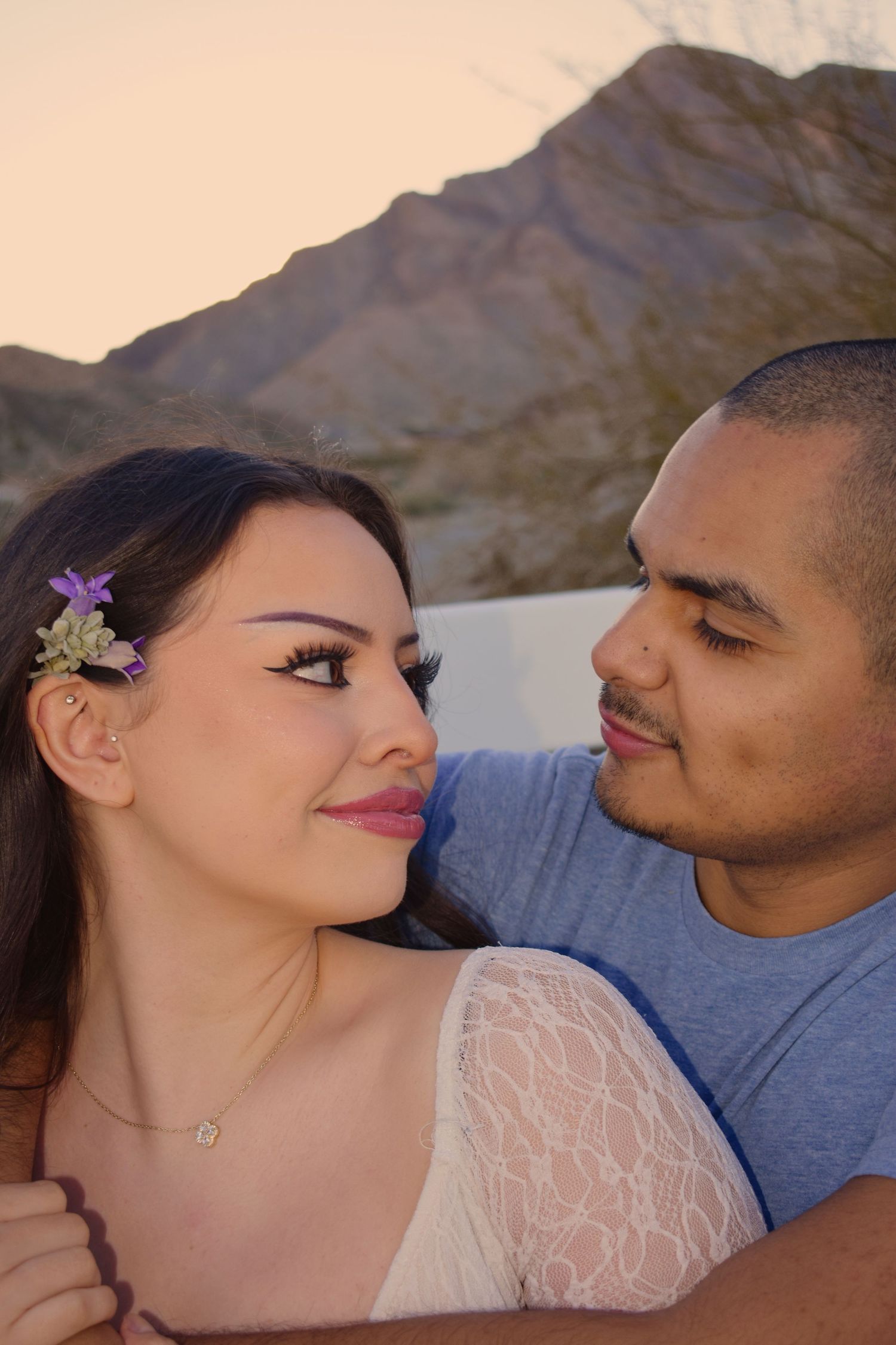 A couple shares intimate moments together in a series of close-up romantic photos against a blurred background.