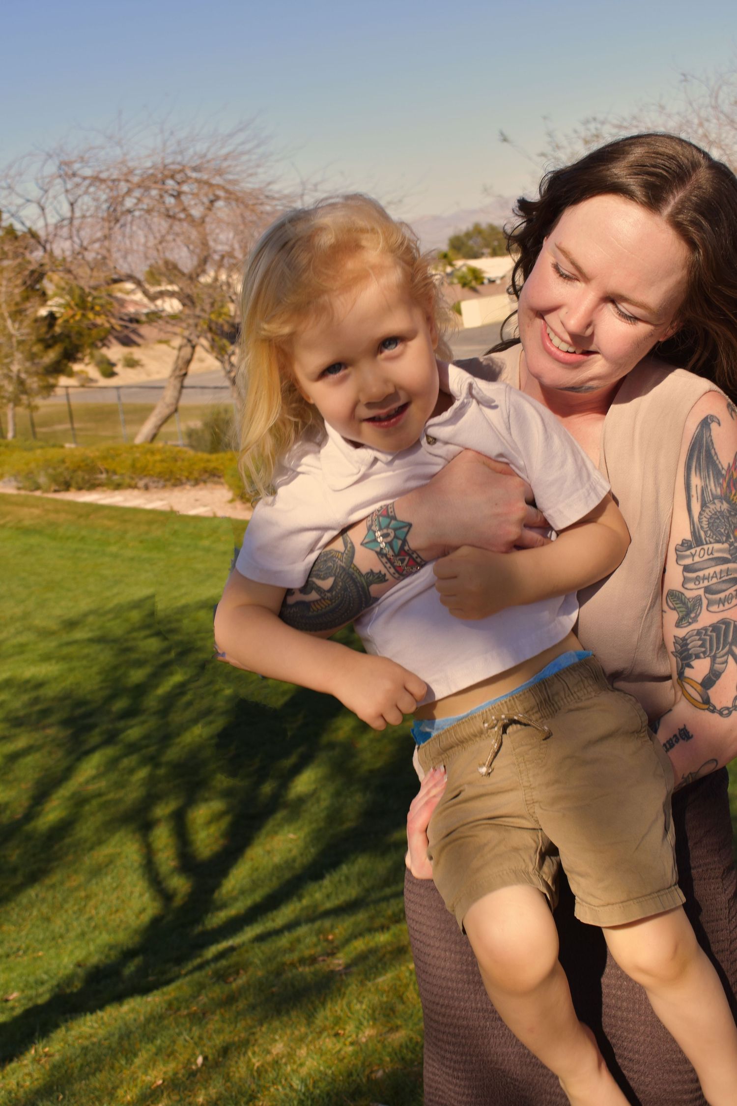 A playful sequence of photos showing joyful interaction and laughter outdoors on a sunny day in a grassy area.