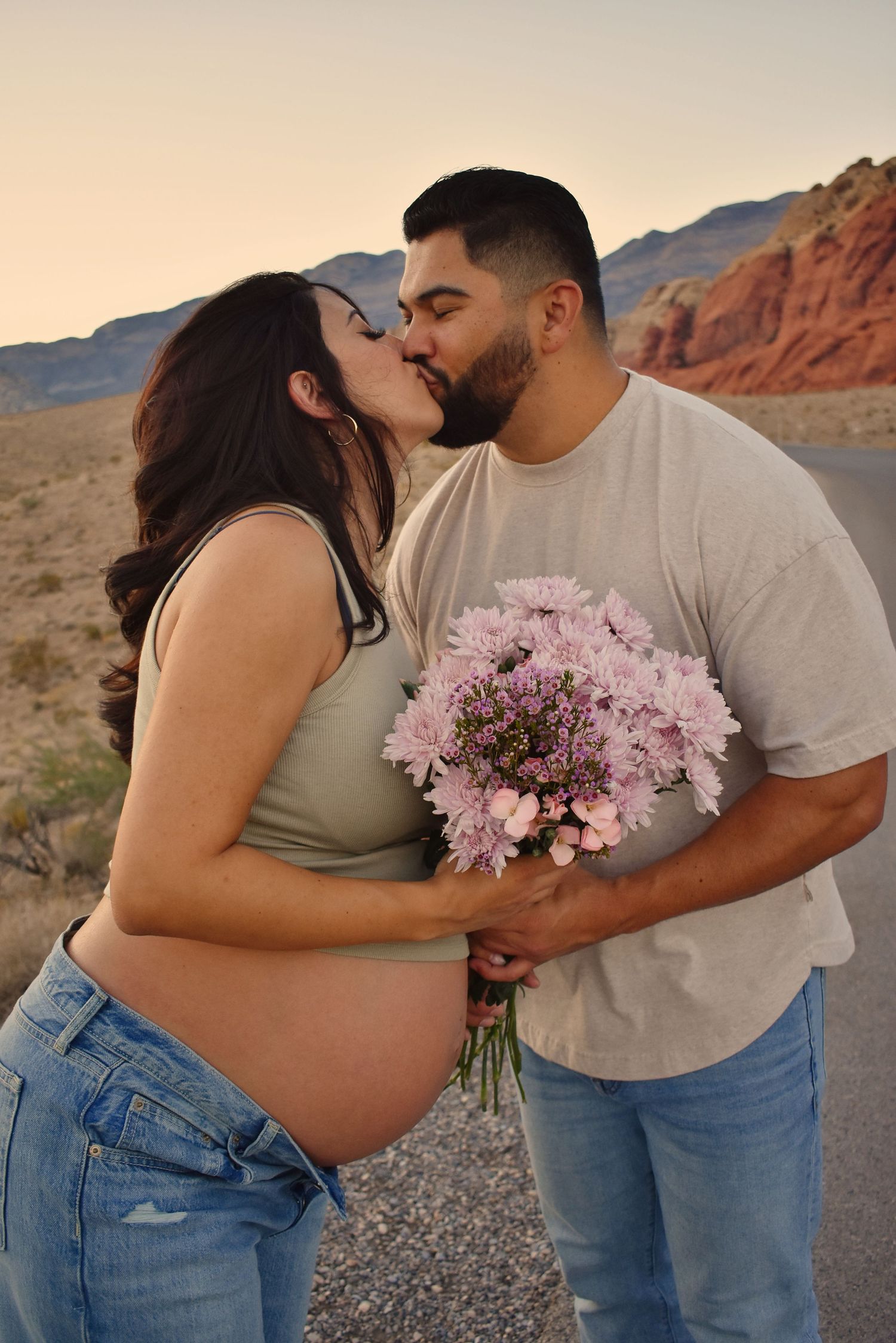 Romantic moment with pink flowers between couple at Red Rock Canyon.