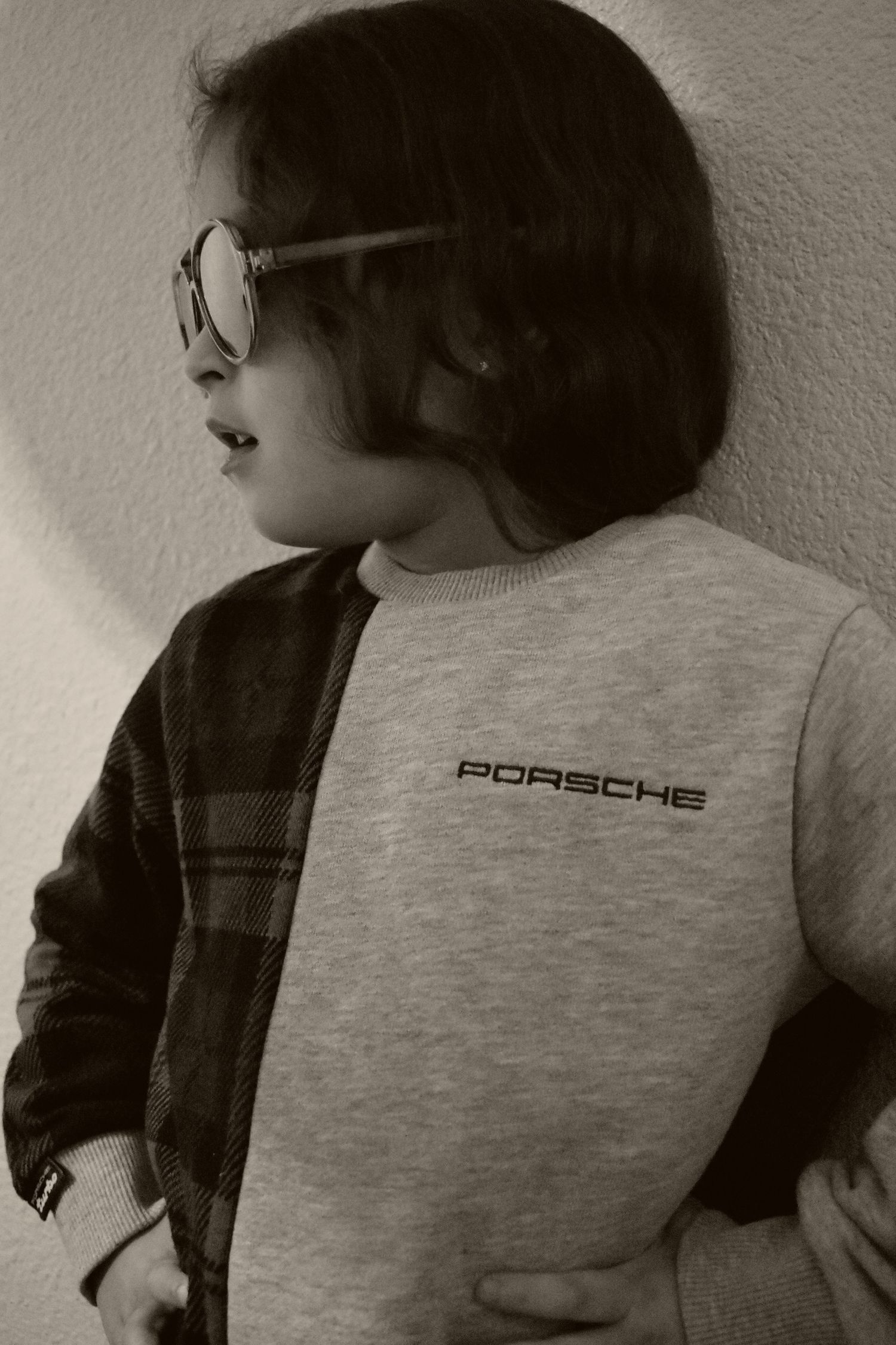 Gray Porsche logo t-shirt shown in black and white photography.