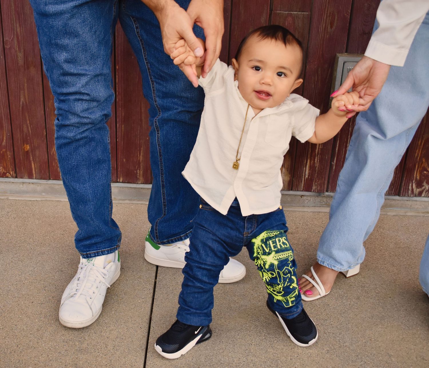 Candid family moments captured at ground level showing casual denim and white outfits.
