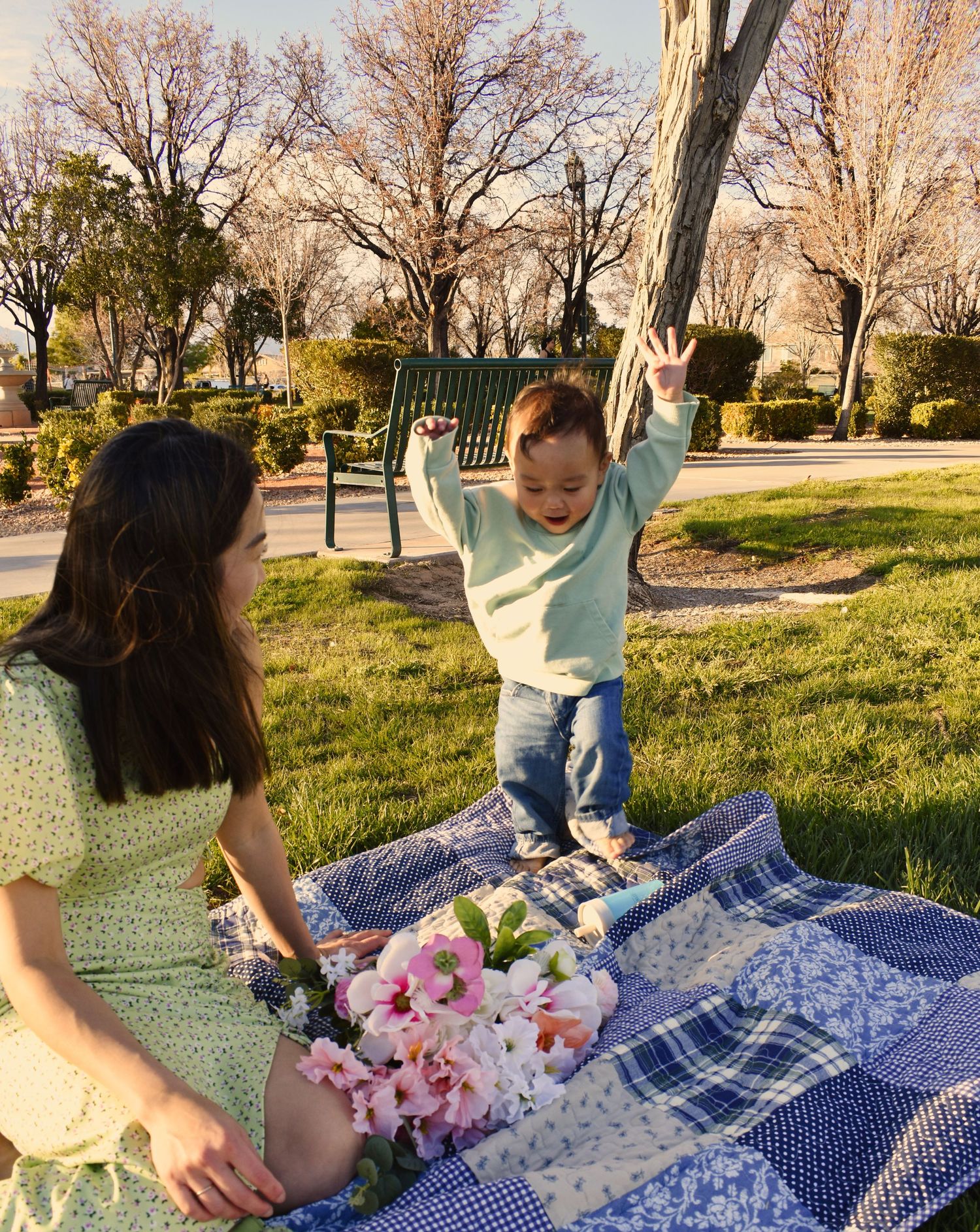 A sequence of photos showing someone playing with toys on a blue checkered blanket outdoors on a sunny day.