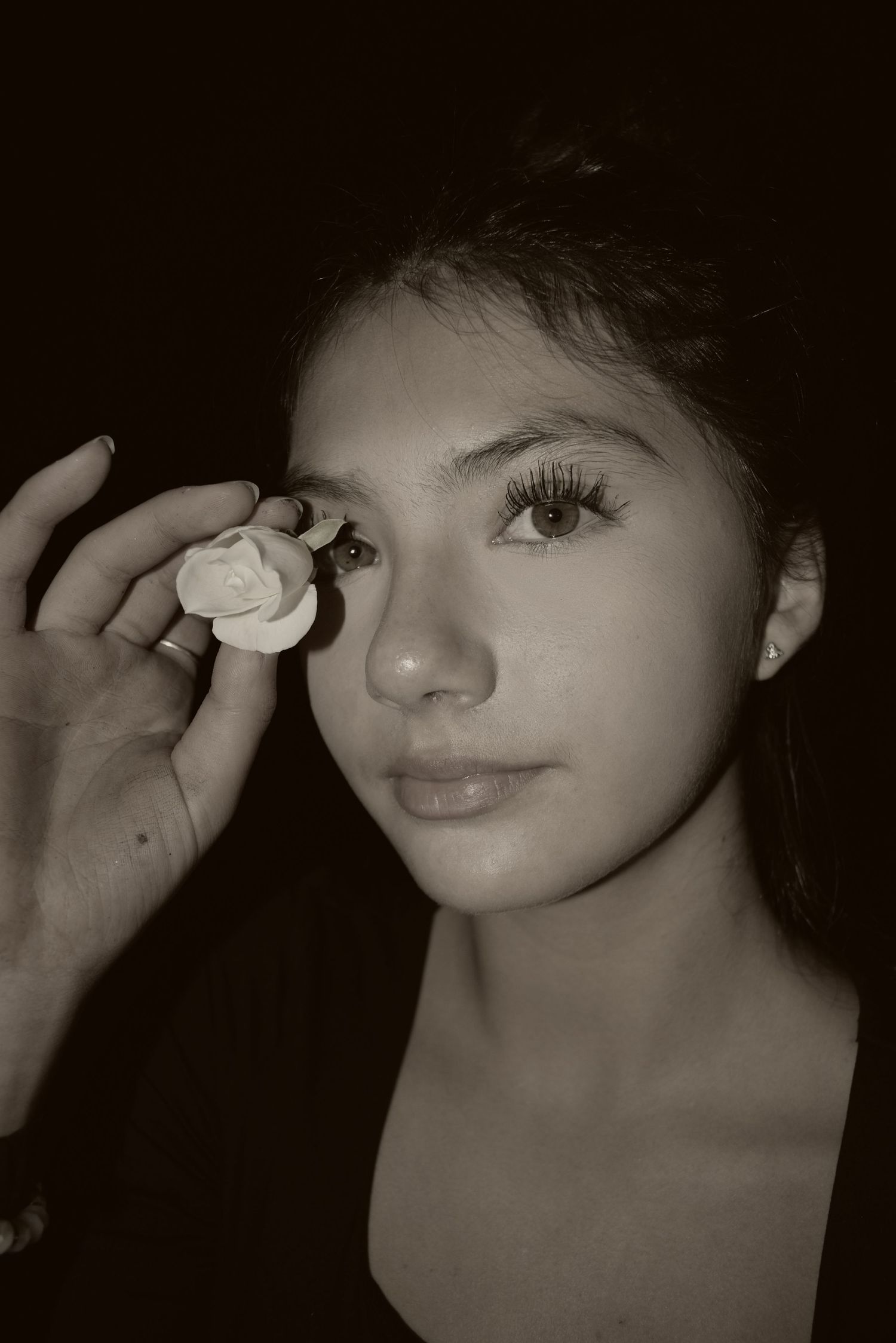 Artistic close-up portrait sequence in black and white with dramatic lighting.