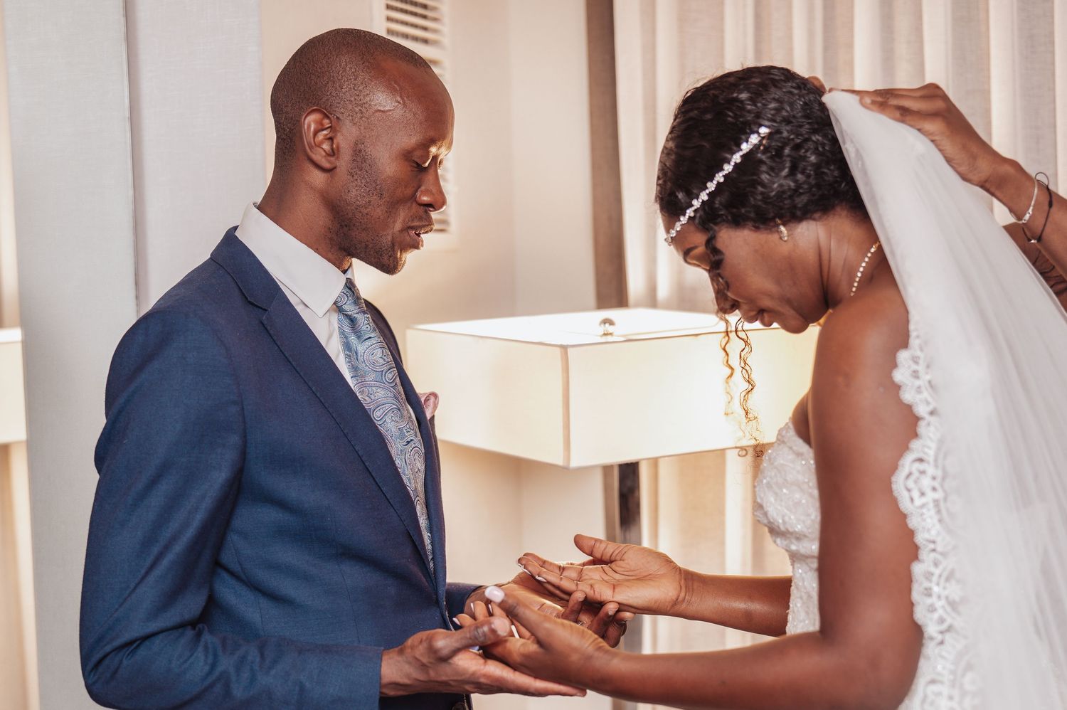 Intimate moment of couple exchanging rings during wedding ceremony.