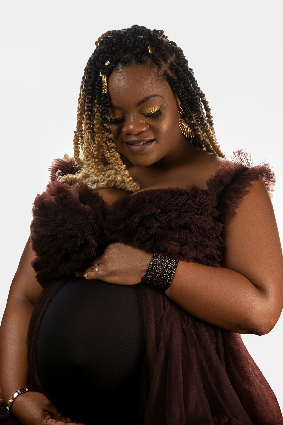 Elegant portrait series with black dress and brown feather accent.