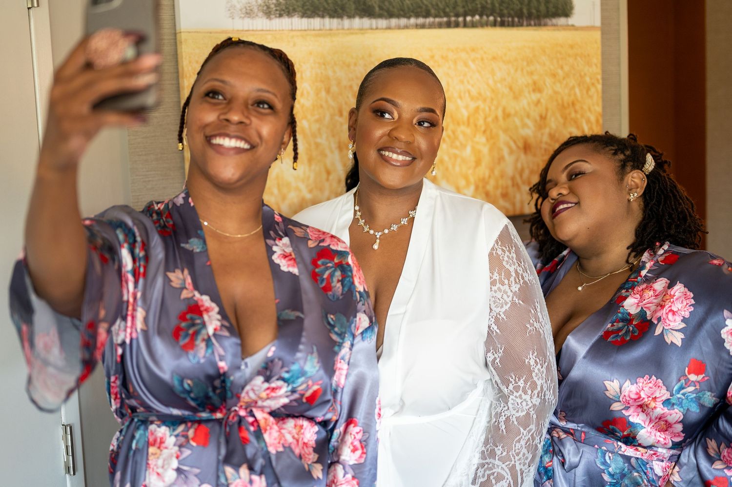 Wedding party takes selfie together during pre-ceremony preparations.