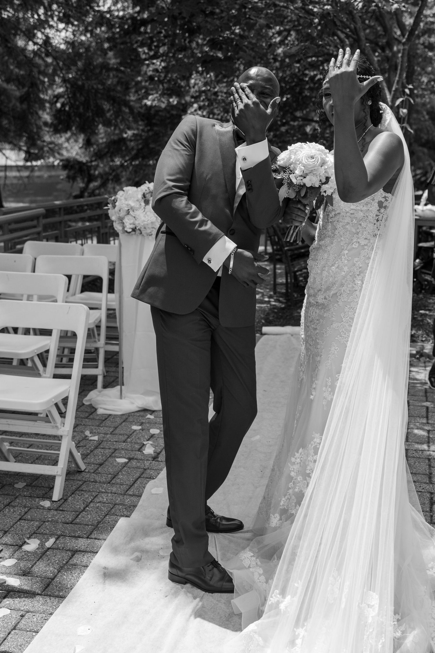 A tender wedding moment captured in black and white as the couple shares an emotional first look.