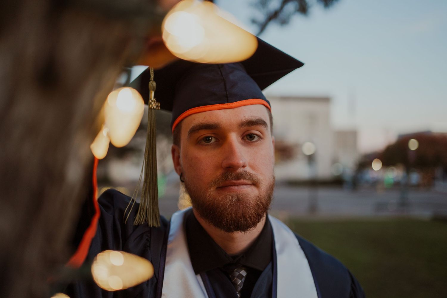 Outdoor evening scene with warm glowing lights and bokeh effect.