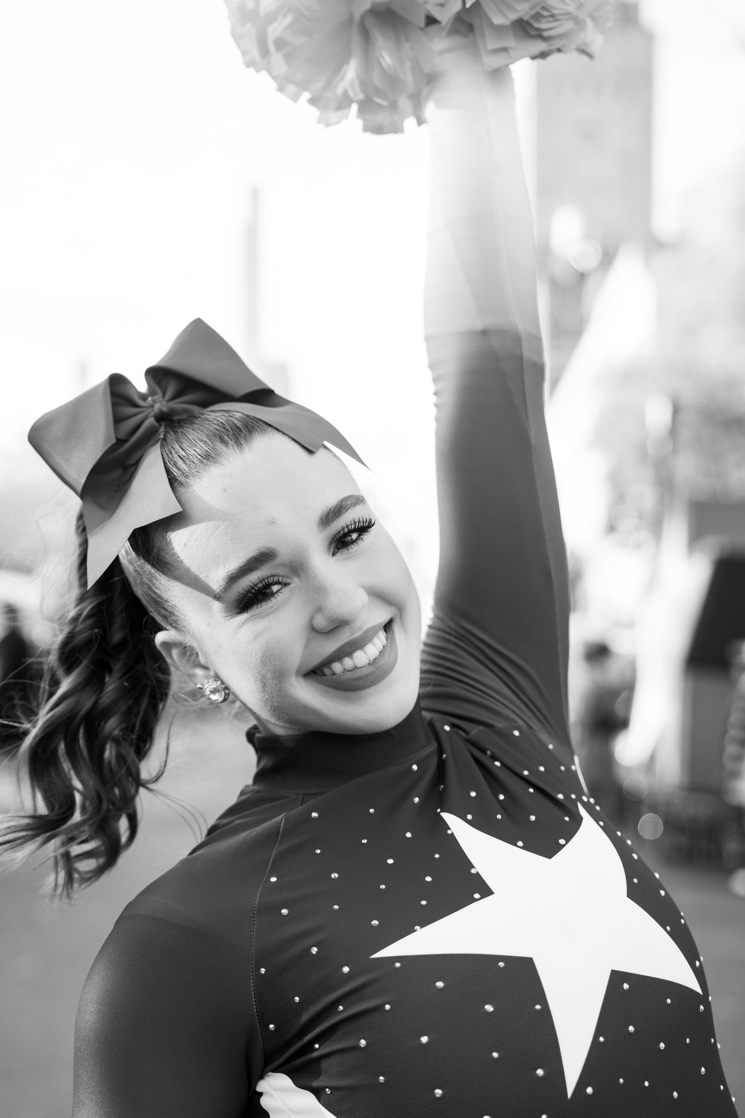Black and white photo collage showing joyful expressions and movement in polka dot top with star detail.