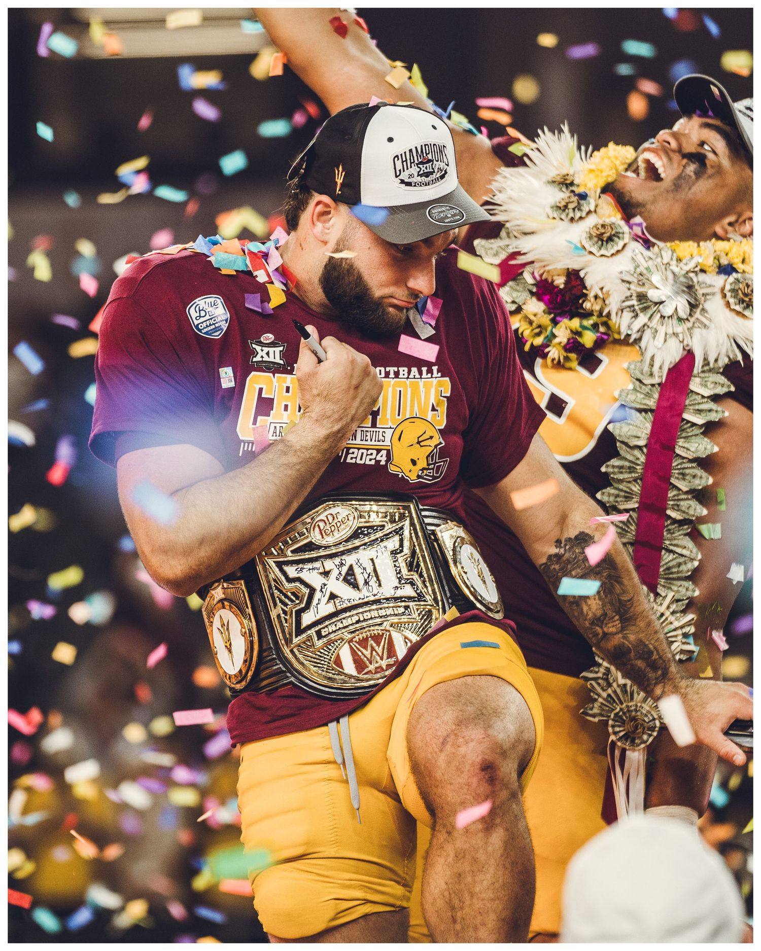 Championship celebration moment with confetti falling as victor holds up championship belt during triumphant sports victory.