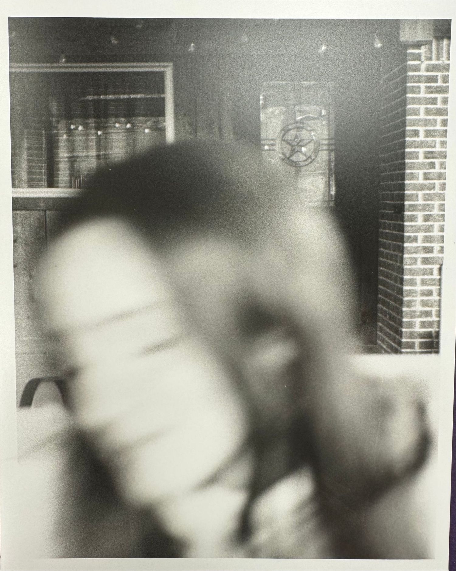 A series of black and white photographs showing blurred motion and abstract forms in an indoor setting.