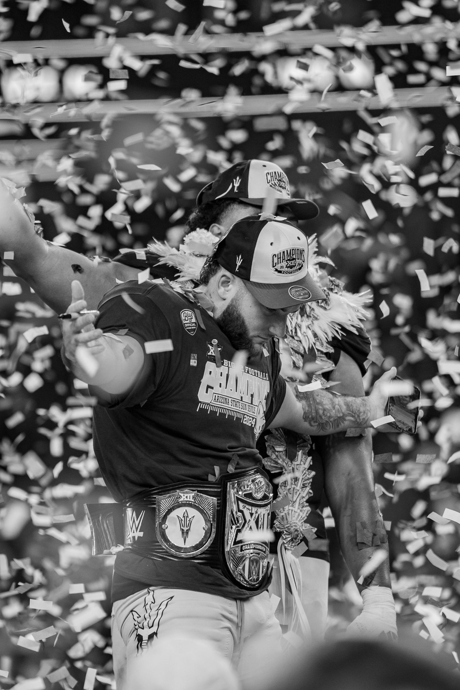 Sports celebration scene with white confetti falling in black and white.