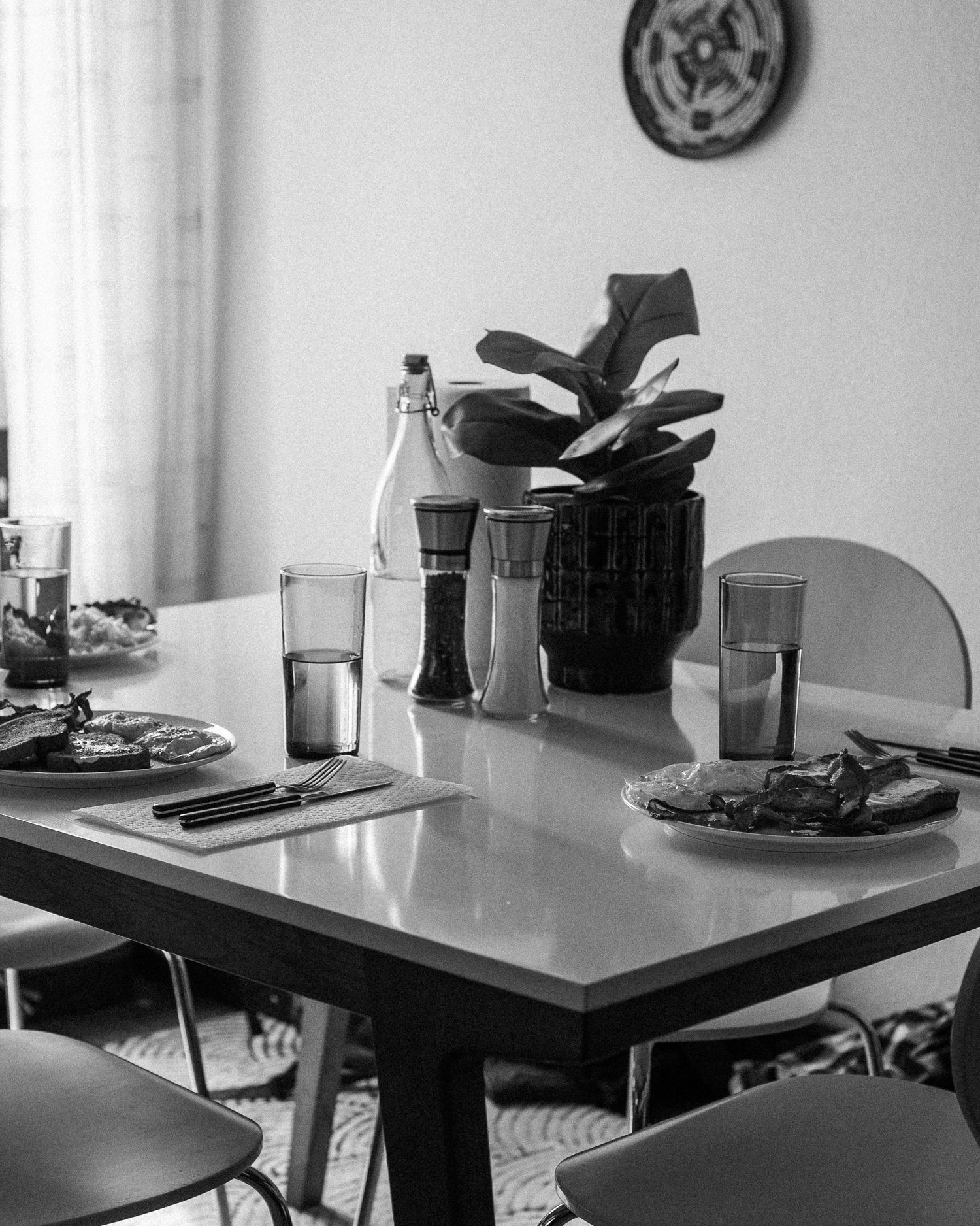 Black and white image sequence showing a table setting progressively fading away from left to right.