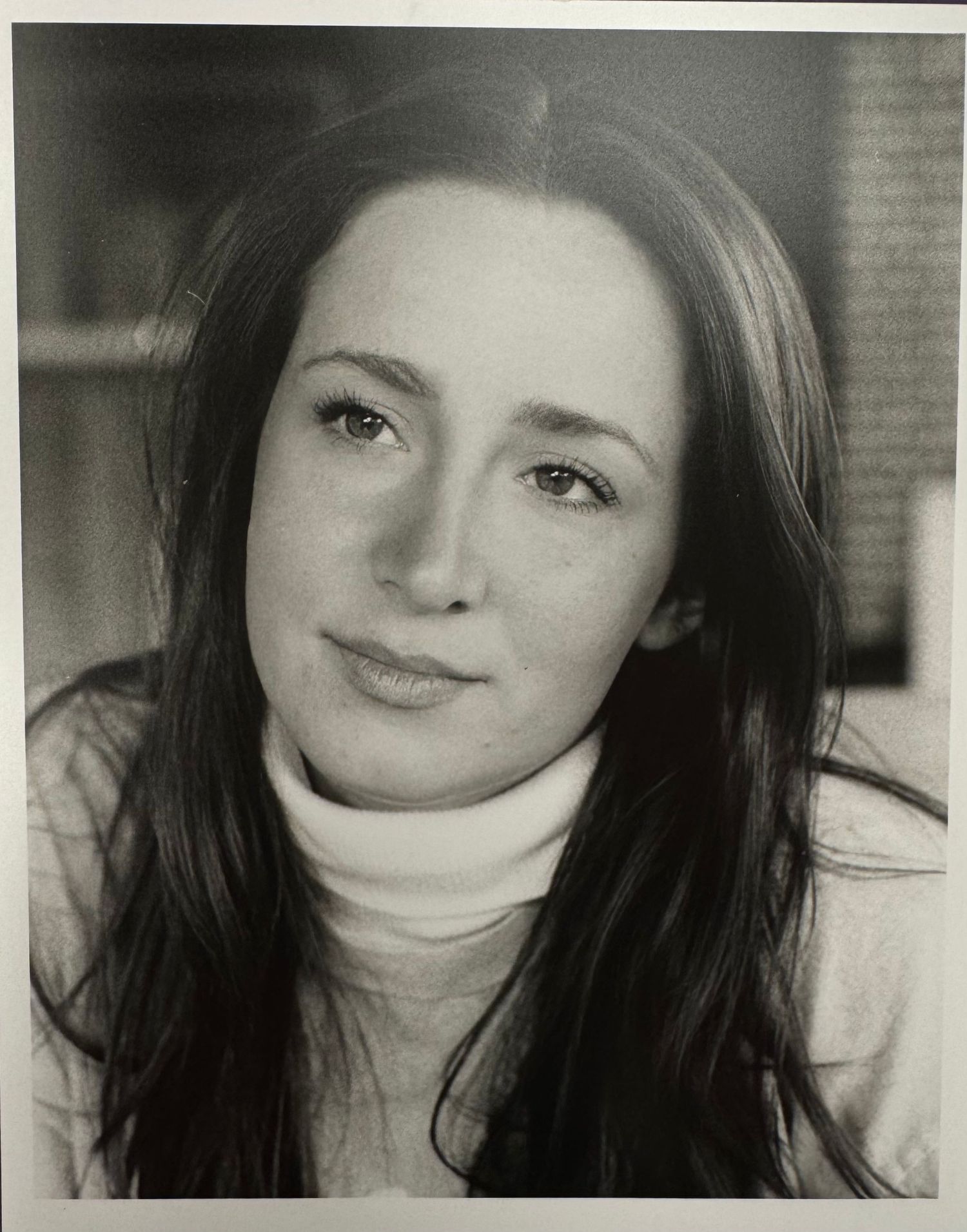 A series of black and white portraits showing someone with dark hair and a gentle smile looking at the camera.