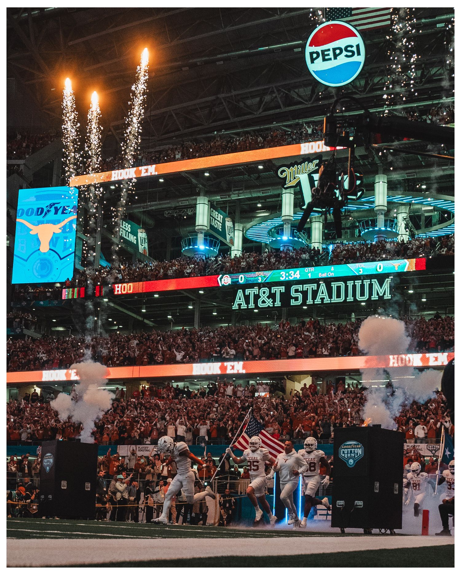 Stadium lighting illuminates AT&T Stadium with pyrotechnics and crowd displays.