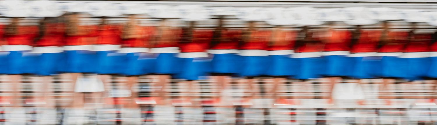 Red, white and blue striped banners or decorative elements against a blurred background.