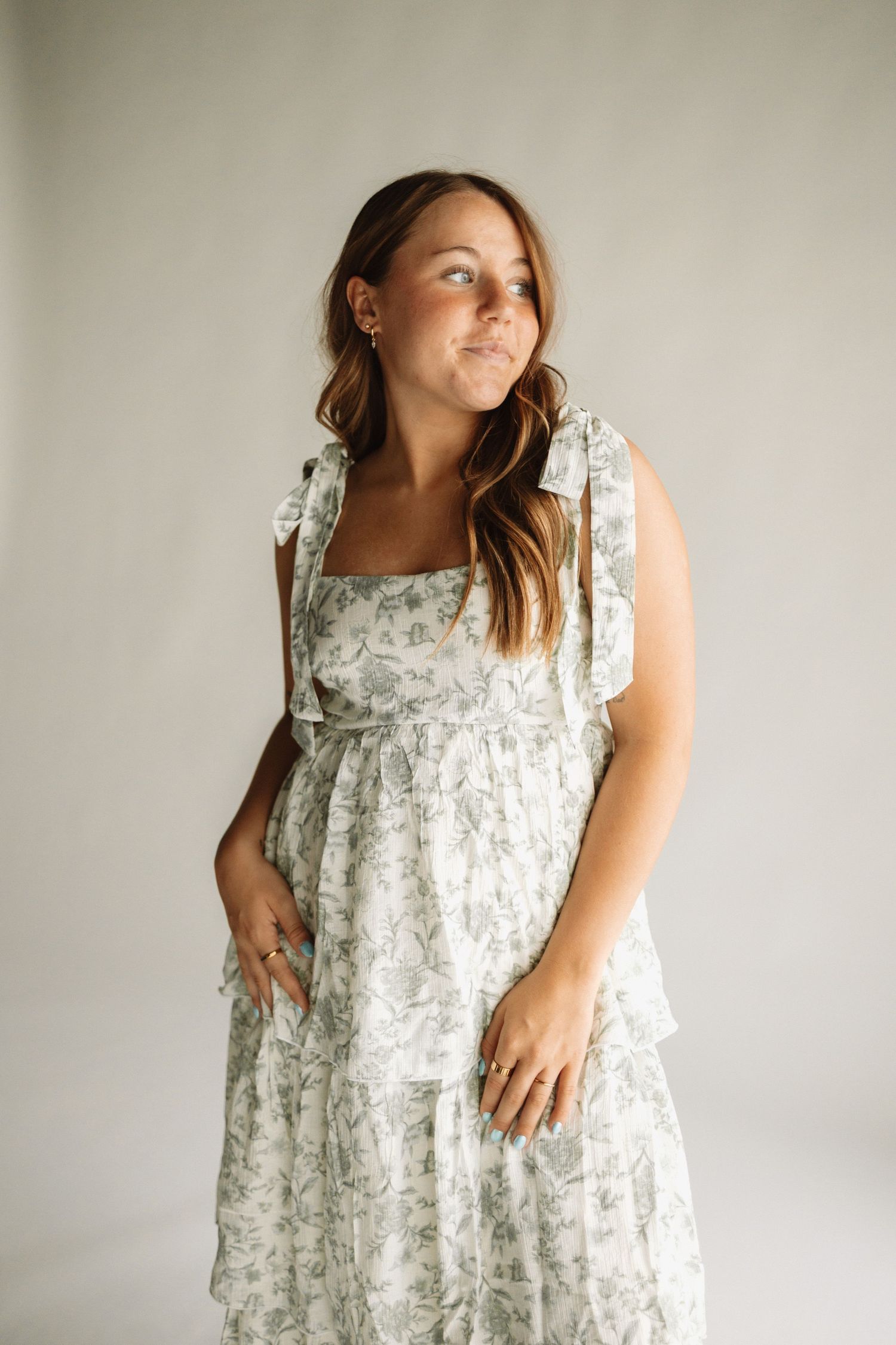 A floral print sleeveless dress shown in multiple angles against a light background.