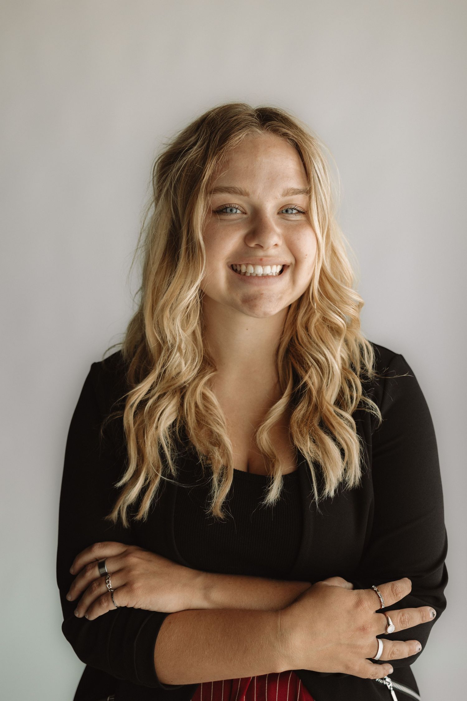 A series of candid black and white portraits showing natural expressions and flowing blonde hair against a light background.