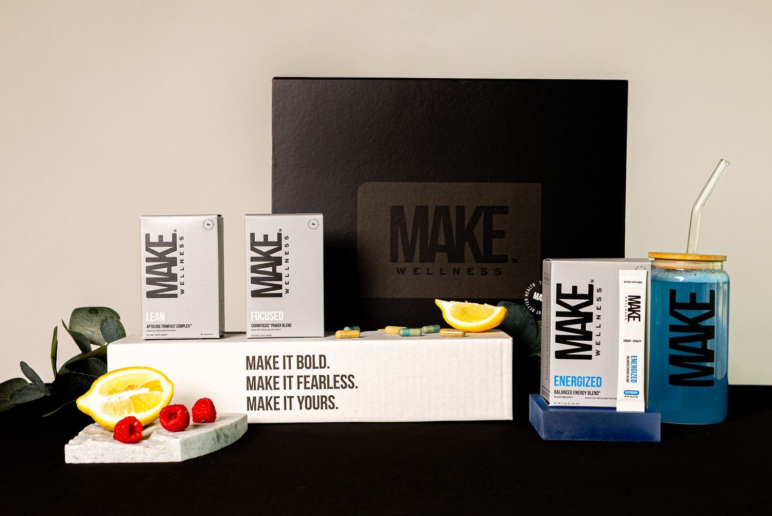 A series of product boxes and packaging materials arranged in a minimalist display against a dark background.