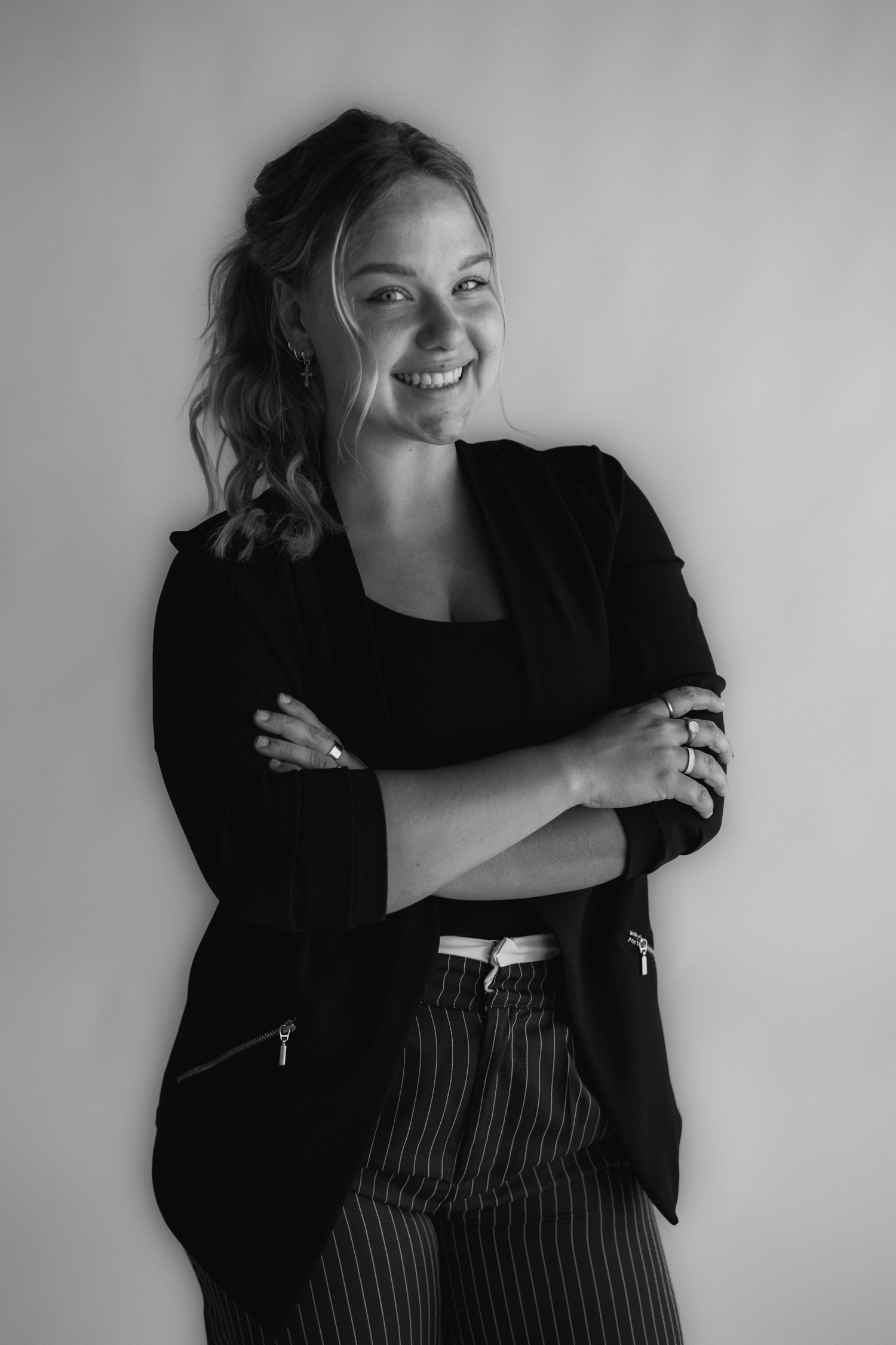 Black and white fashion portraits featuring relaxed poses in a black jacket and pinstriped outfit.
