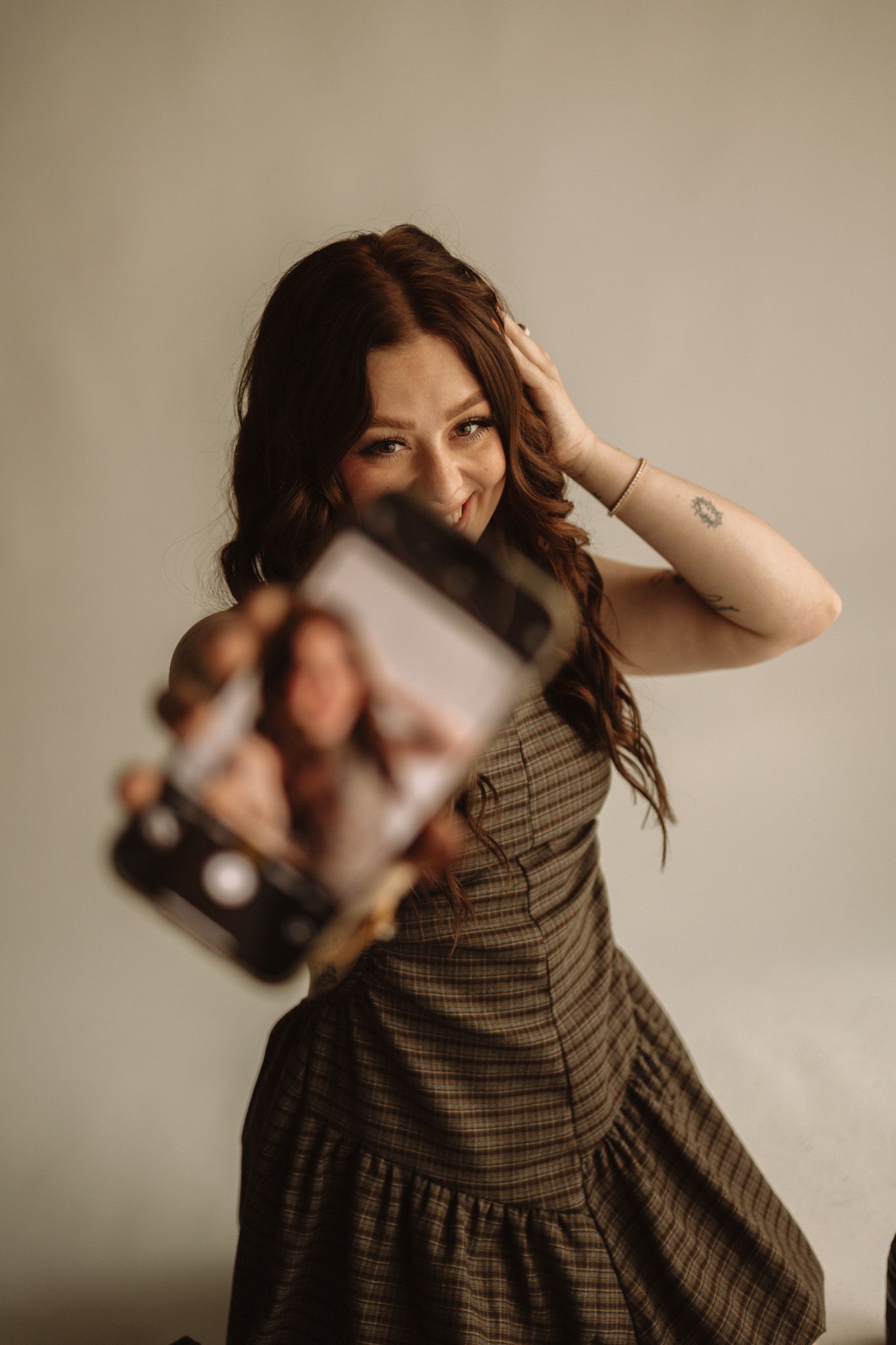 A person in a brown plaid shirt strikes dynamic poses across multiple connected images in an artistic portrait series.