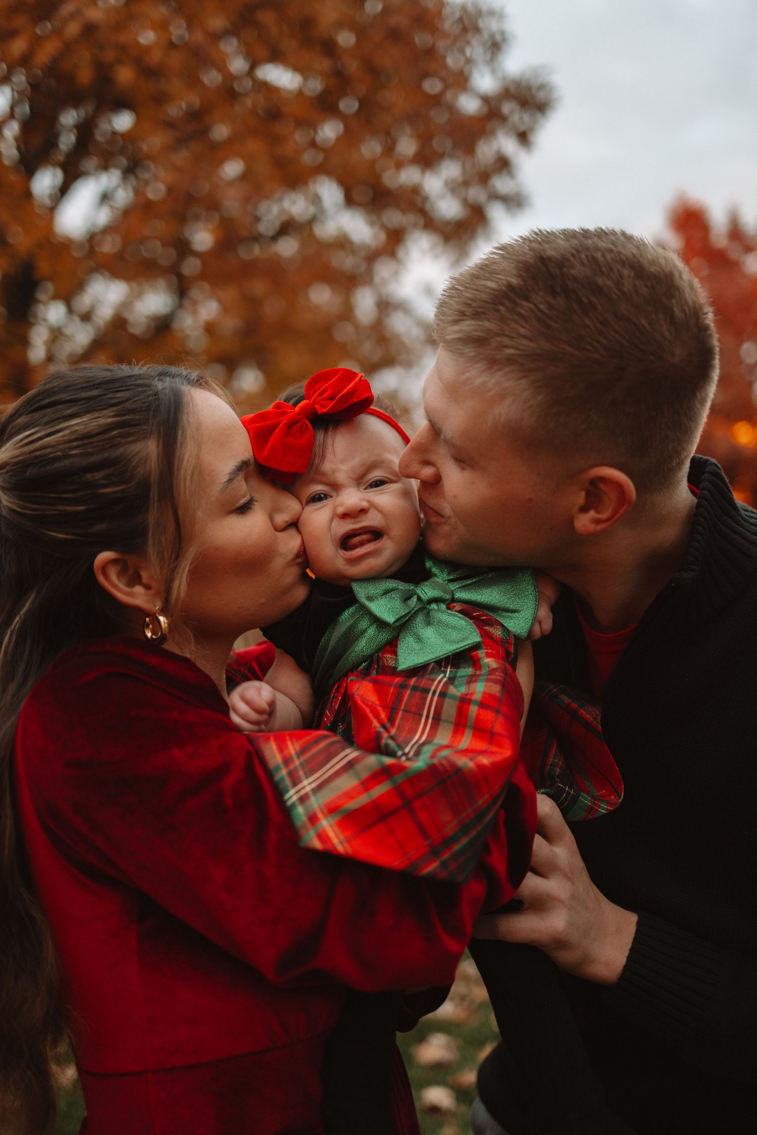 A series of candid family photos showing affectionate moments between siblings in red and green holiday outfits during autumn.