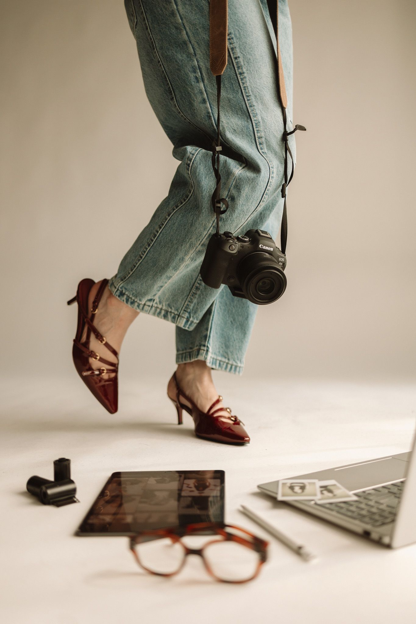 Series of close-up shots showing jeans, glasses, laptop and footwear arranged in a minimalist lifestyle composition.