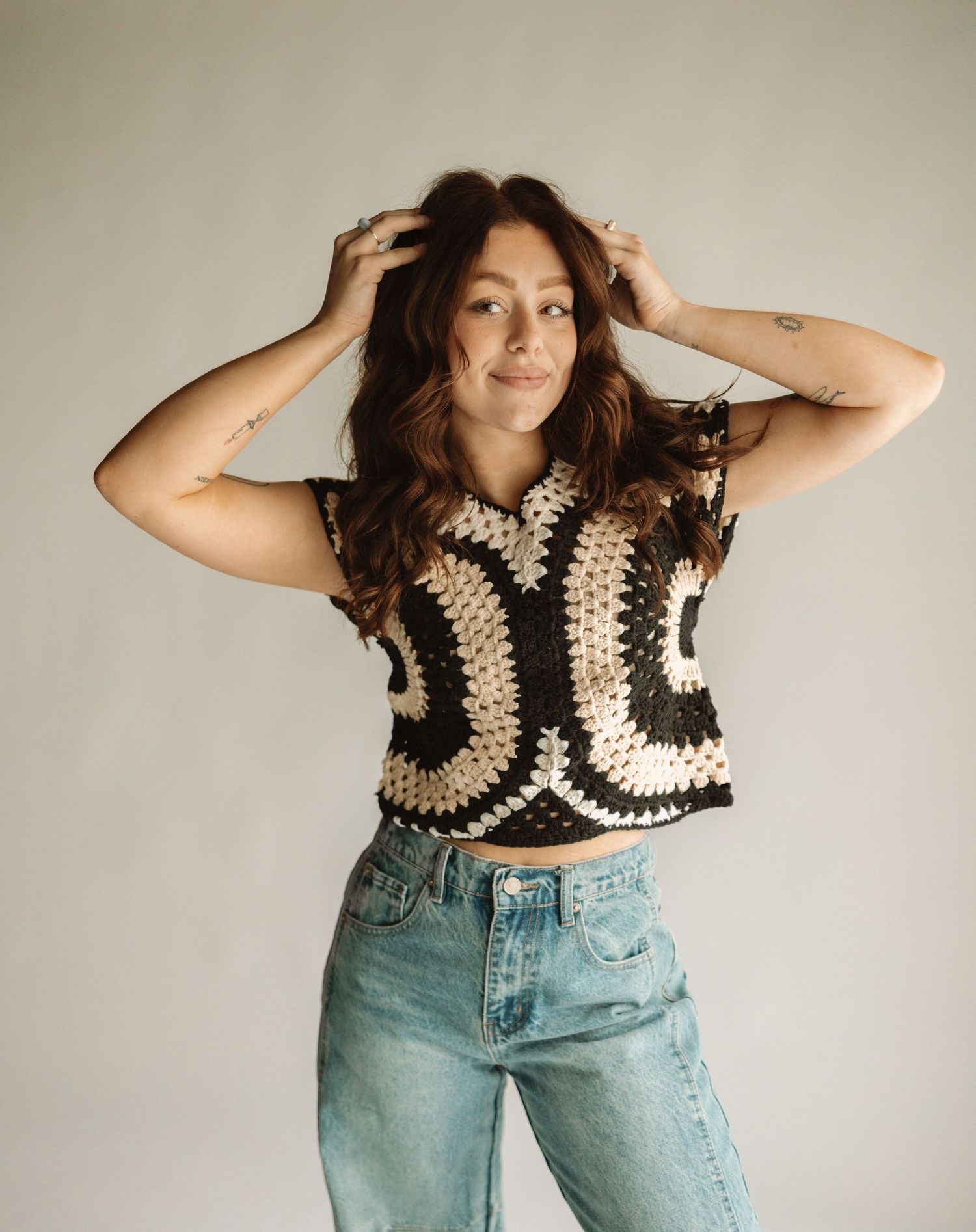A series of fashion photos showing a crochet crop top paired with light wash mom jeans in a vintage style photoshoot.