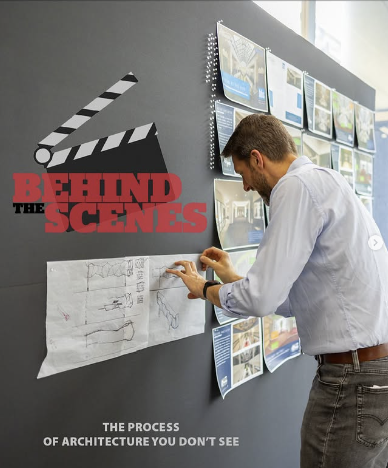 Person viewing architectural plans and drawings on a wall display titled Behind the Scenes, with a film slate icon.