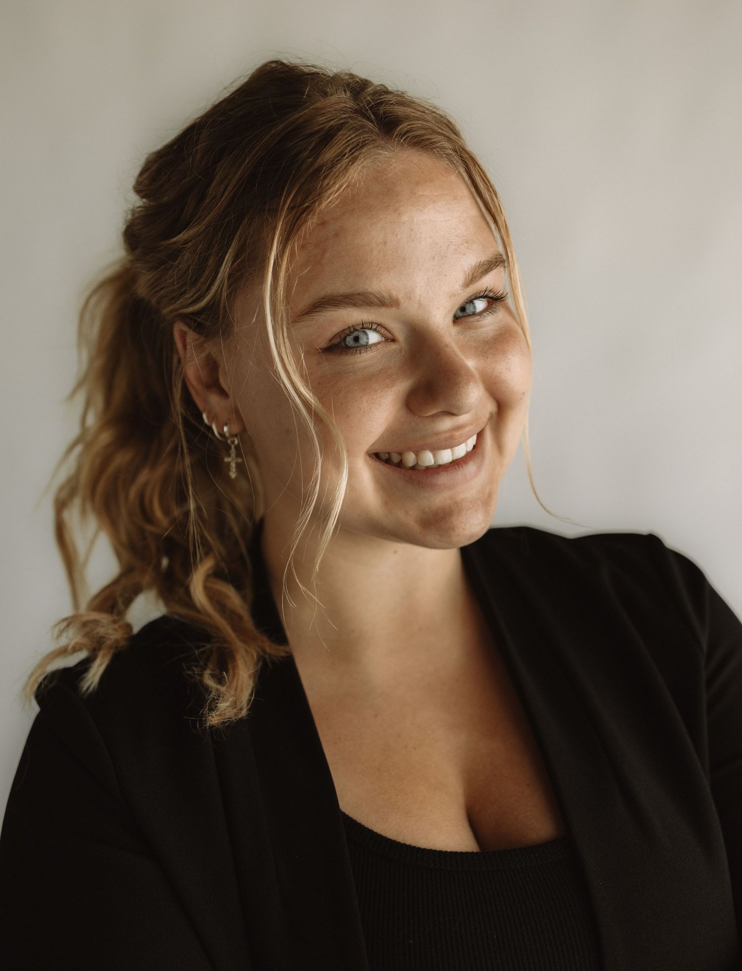 A series of candid portrait shots showing joyful expressions and playful poses against a light background.