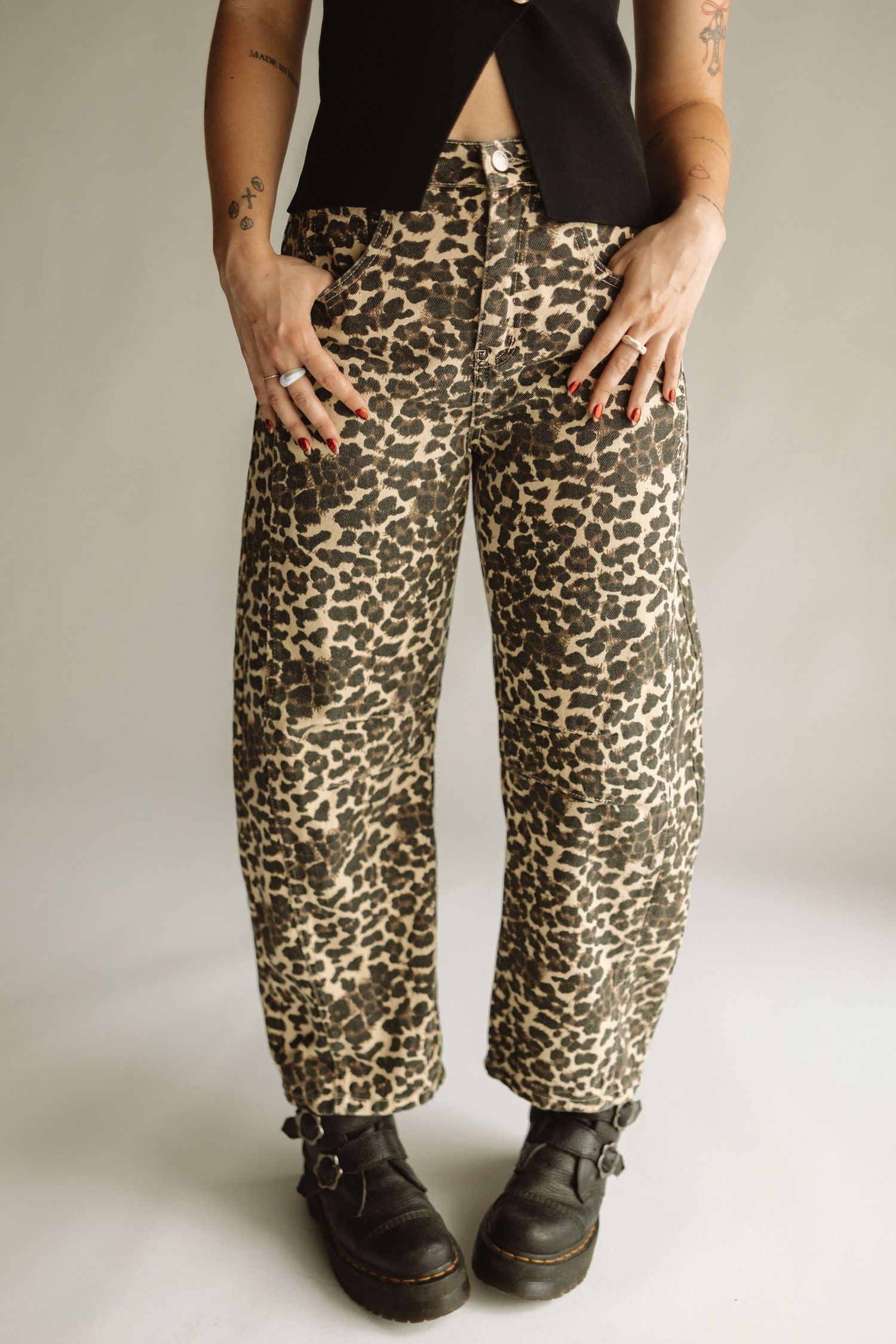 Close-up photo sequence showing leopard print pants from different angles on a light background.