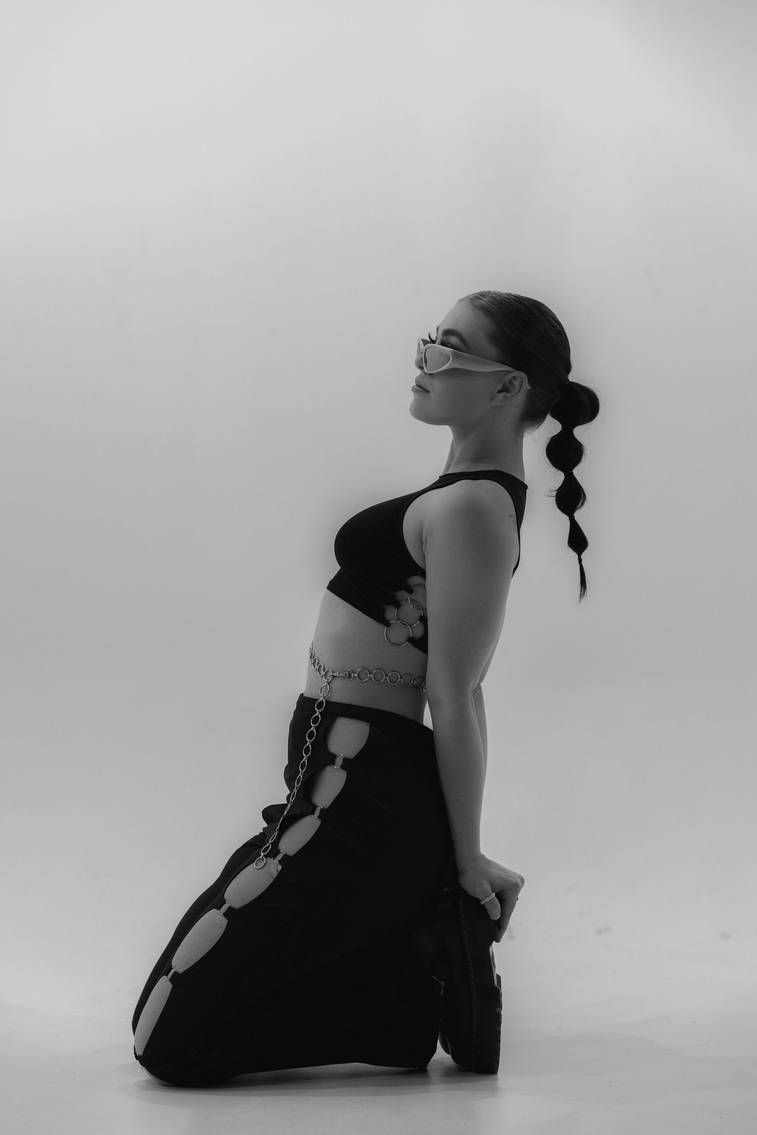 Black and white sequence showing a figure moving through yoga positions in a minimalist setting.