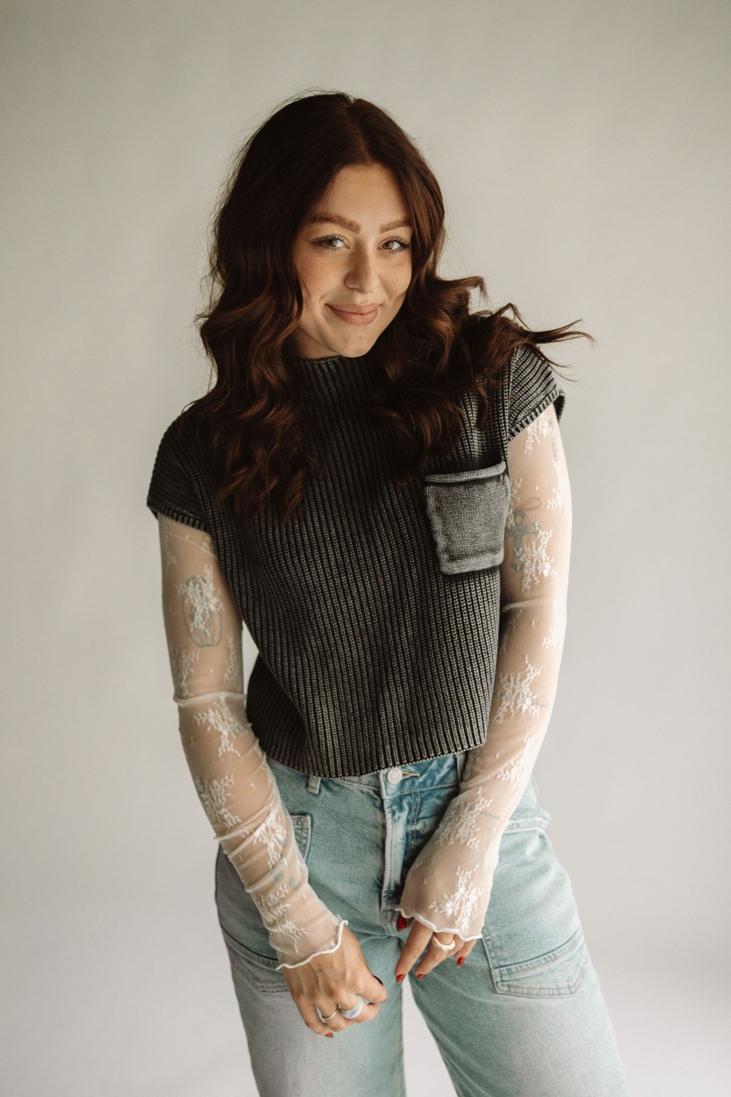 A fashion collage showing a ribbed sleeveless top paired with light denim jeans and sheer long sleeve mesh top.