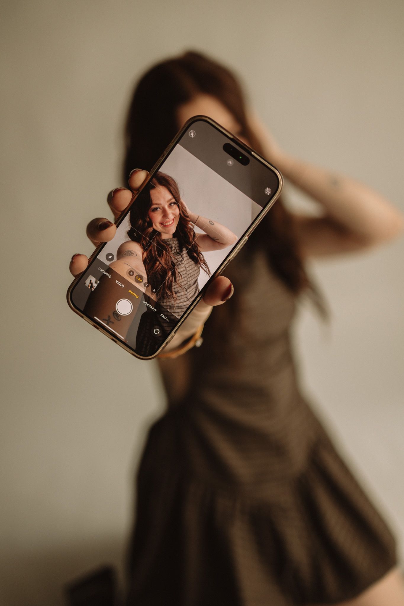 A sequence of artistic self portrait shots with a smartphone in warm brown tones showing movement and blur.