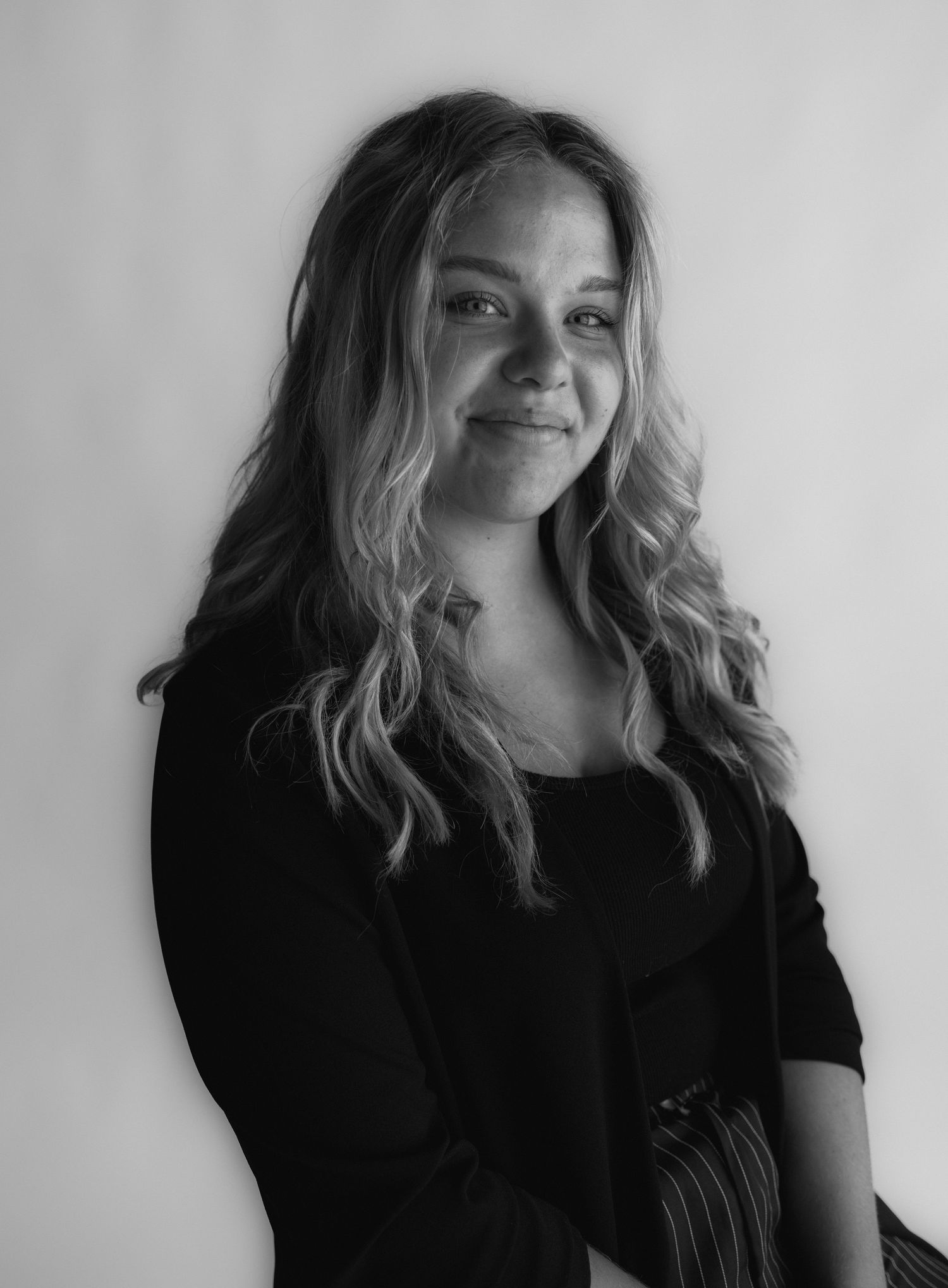 Artistic black and white portrait series showing a person with tousled blonde hair against white background.