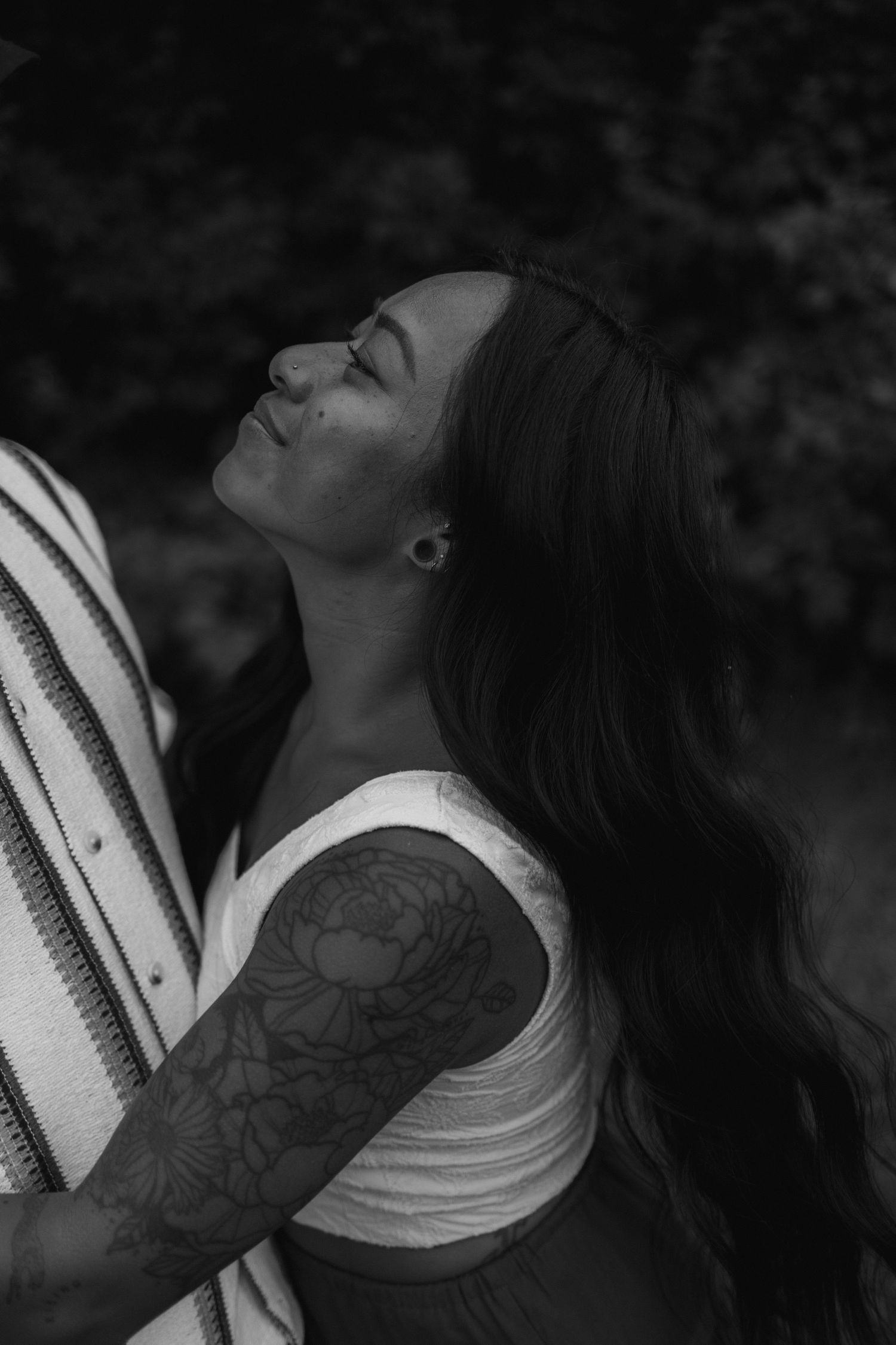 Black and white artistic photo sequence showing a tattooed person in profile view with head tilted back against dark background.
