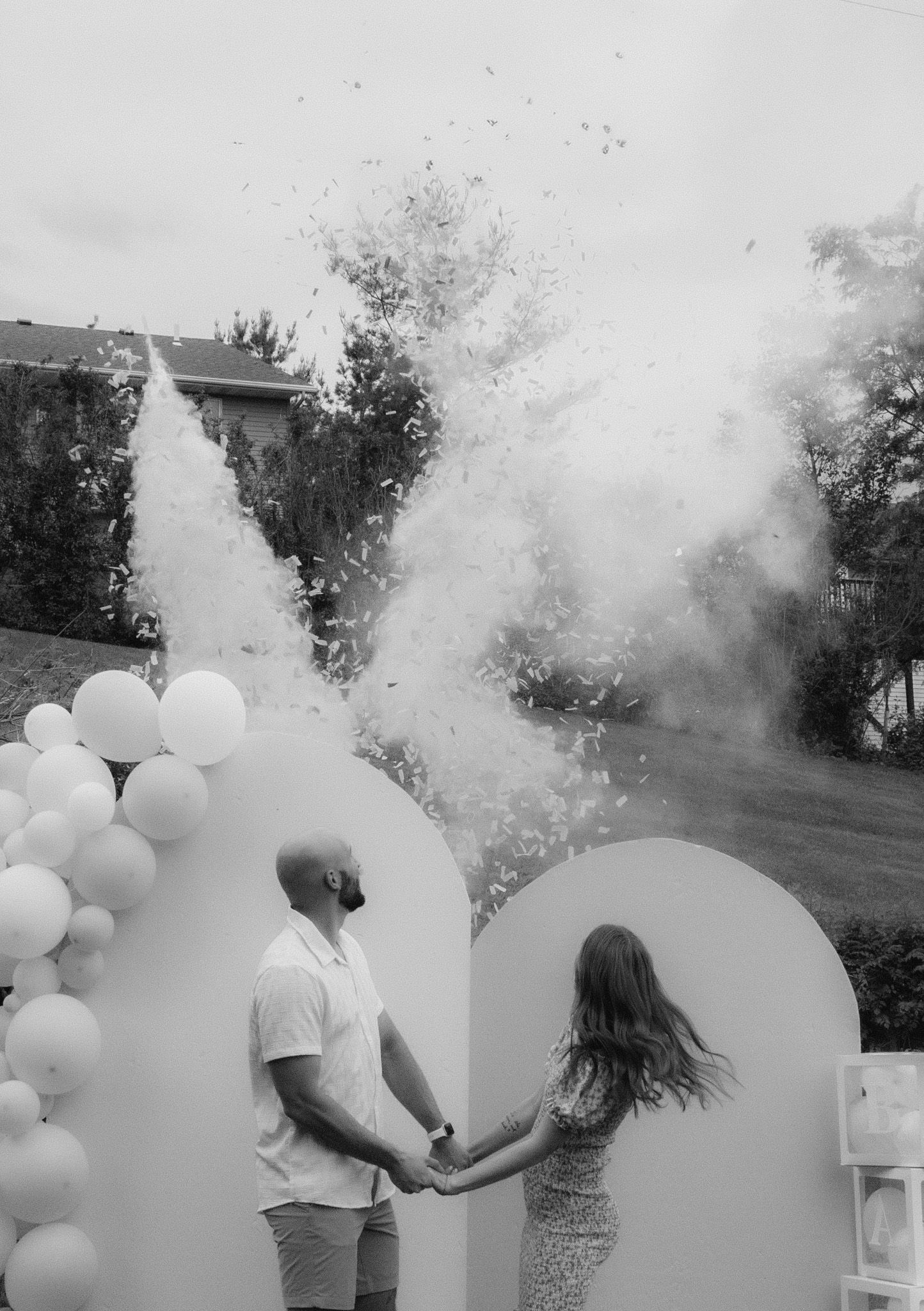 Smoke bomb and balloon gender reveal celebration sequence outdoors.