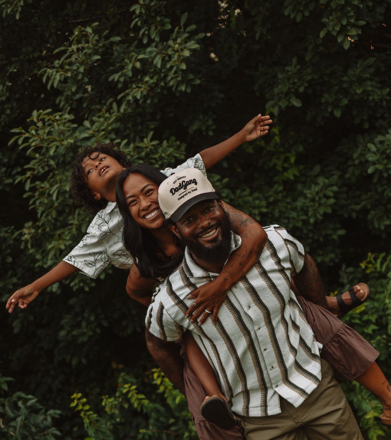 People having fun outdoors as they playfully pose for a series of candid photos in a natural setting.